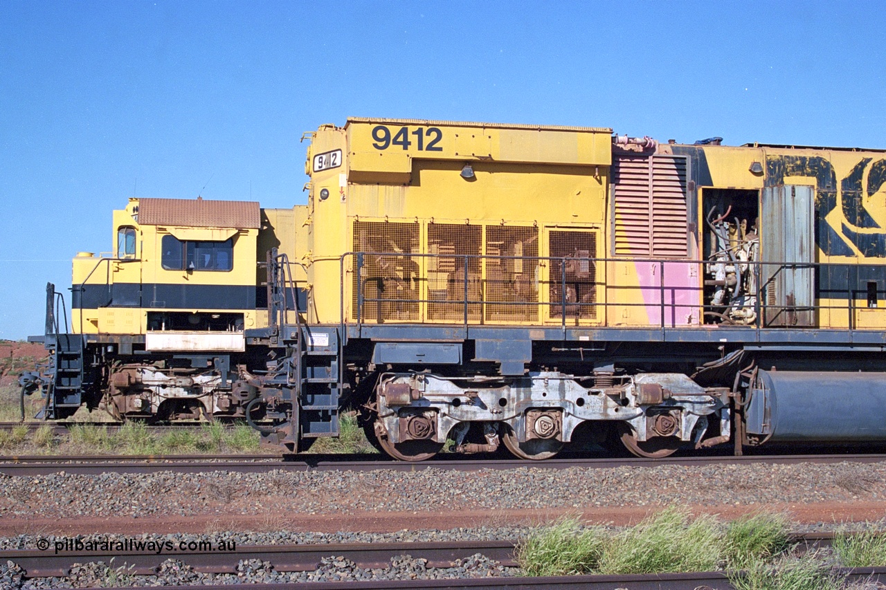 248-19
Seven Mile yard, stored Robe River ALCo locomotives at the south end of the Hamersley Iron Seven Mile yard on roads N2 and N3. On N2 is a radiator view of AE Goodwin built ALCo M636 unit 9412 serial G-6060-3 from December 1971 and originally numbered 262.003 during construction and then 1712. Behind it on N3 is the cab of 9416 also an AE Goodwin built ALCo M636 serial G-6046-16 from January 1973 and originally numbered 1716. Approximate [url=https://goo.gl/maps/CXwAreRPb2RymQ9m9]location[/url]. 24th April 2004.
Keywords: 9412;AE-Goodwin;MLW-ALCo;M636;G6060-3;