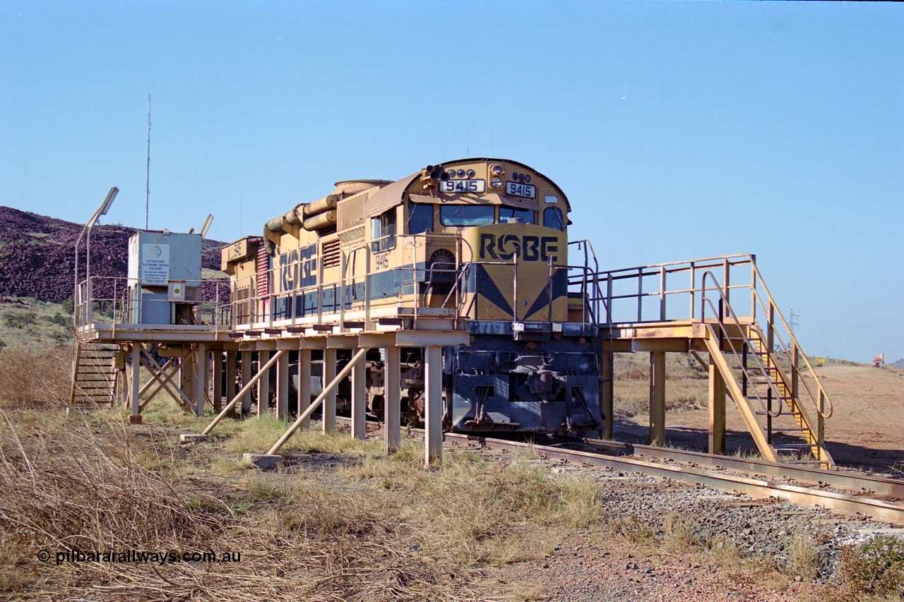 250-31
Cape Lambert yard in the Load Box is recently stored Robe River AE Goodwin built ALCo M636 unit 9415 serial G6060-6 from February 1973 and was an extension of the original order and delivered with cab side numbering of 86-14-1715 and number boards as 1715. The ducting on the hood is the air to air intercooler modifications. 22nd October 2000.
Keywords: 9415;AE-Goodwin;MLW-ALCo;M636;G6060-6;