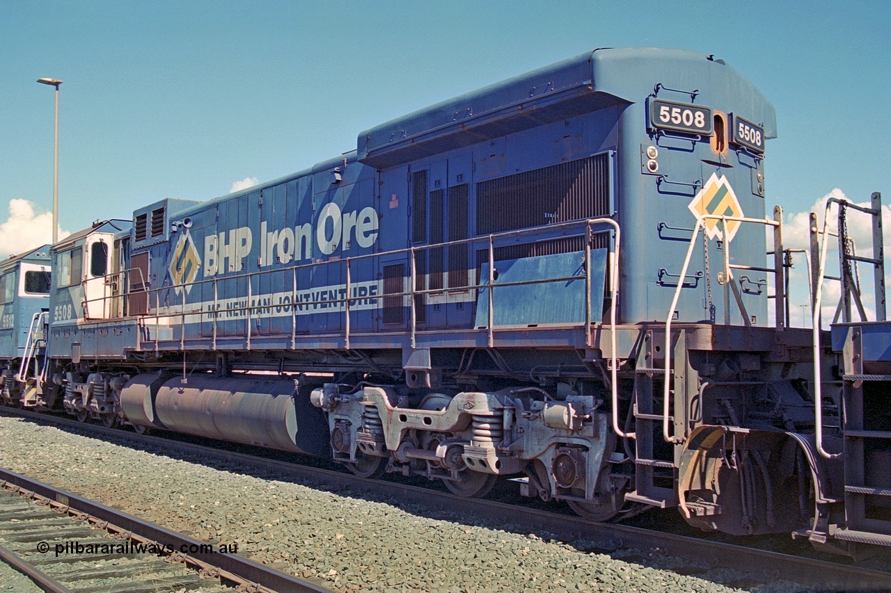 251-03
Nelson Point, BHP's recently retired Goninan WA ALCo C636 to GE C36-7M rebuild unit 5508 awaits its fate. Rebuilt in 1987 at Goninan's Welshpool factory from 1969 AE Goodwin built ALCo C636 with serial number G6041-2 and road number 5466 and assigned new serial number 4839-04 / 87-073. It was delivered in Mt Newman Mining orange and was named Fortescue. It also carried the marigold and teal version of the Australia map as part of the BHP logo. In 2003 it was fully rebuilt and leased to Pilbara Rail in that livery and numbered 5052. It survives stored at 7 mile complex as at Dec 2021. 22nd April 2000.
Keywords: 5508;Goninan;GE;C36-7M;4839-04/87-073;rebuild;AE-Goodwin;ALCo;C636;5466;G6041-2;