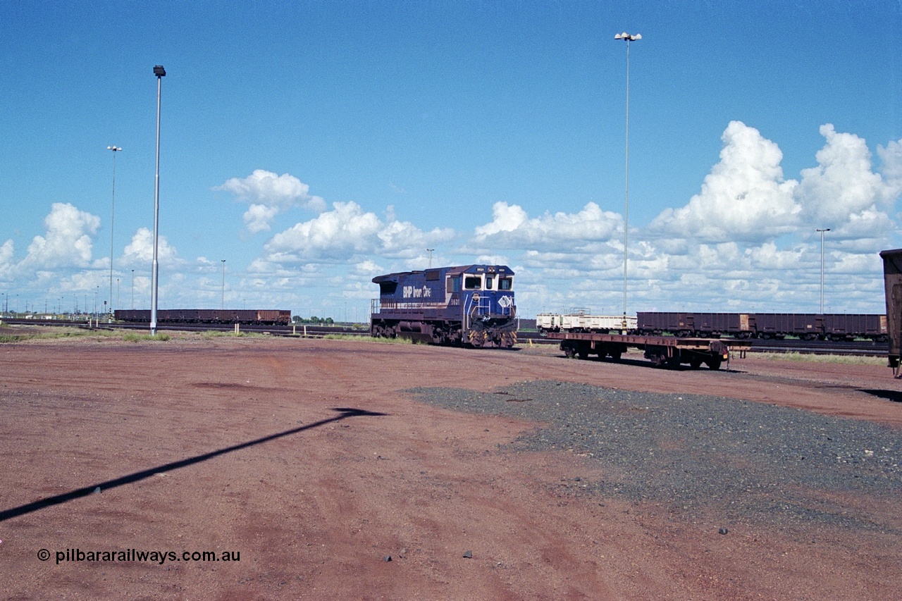 251-30
Nelson Point hard stand area overview sees the CM39-8 model loco 5631, an unidentified flat car and some ore waggons and a compressor set in the distance. 22nd April 2000.
