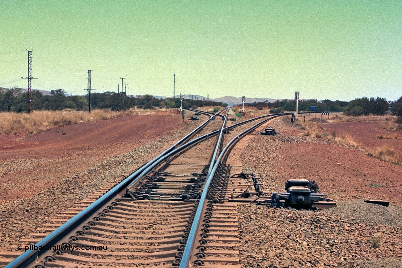 252-17
Rosella Junction looking south at the 251 km. The line to the left goes to Marandoo and Yandicoogina, the straight to Tom Price and Paraburdoo and the right heads to Brockman. Location is roughly [url=https://goo.gl/maps/q3opSy2bPxpd8nv79]here[/url]. 24th November 2001.
