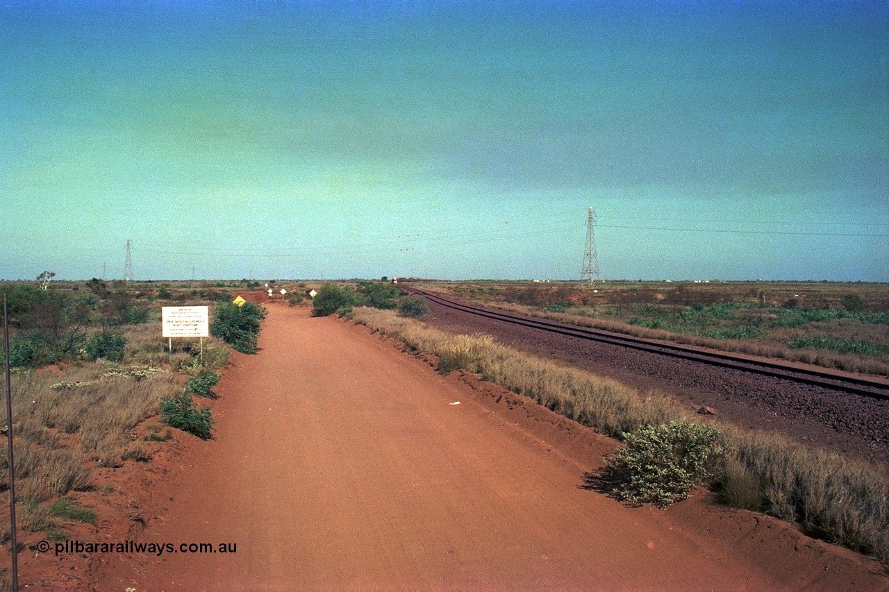 252-29
Port Hedland at 12 Mile Creek a loaded Yarrie train in the distance approaches the creek, the landscape west of Port Hedland is rather flat! Early December 2001.
