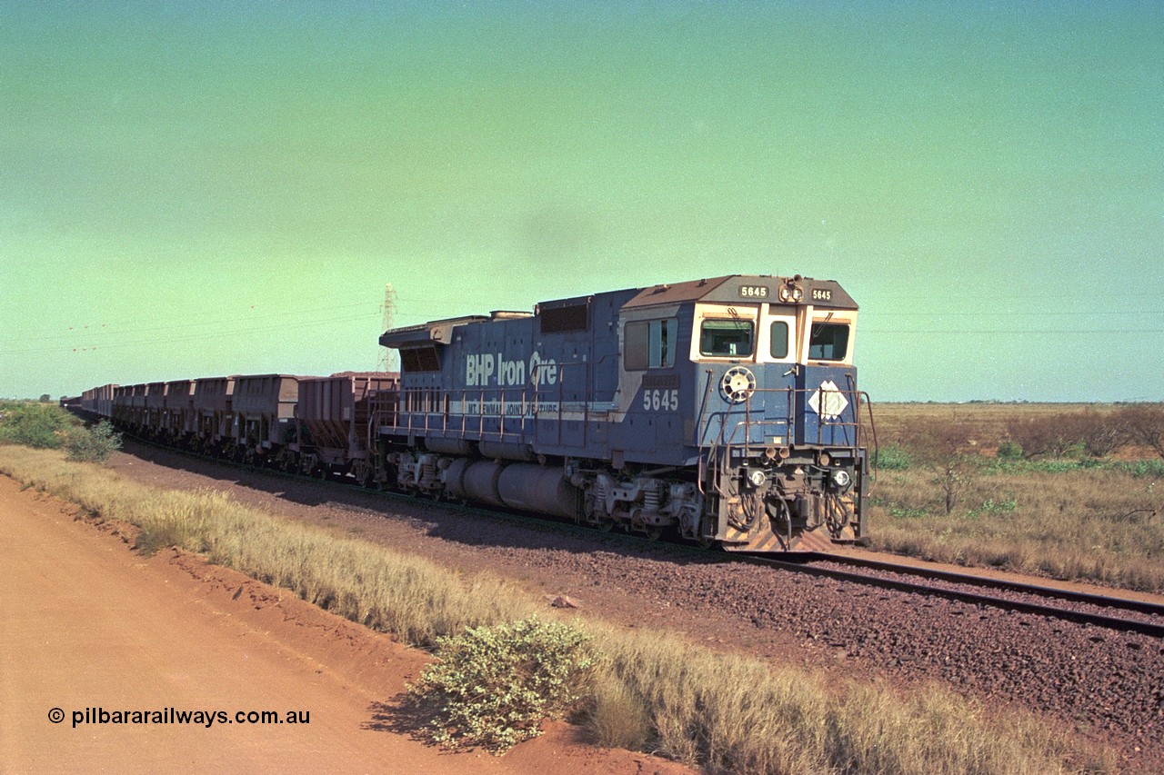 252-33
Port Hedland at 12 Mile Creek a loaded Yarrie train crosses over the creek behind Goninan CM40-8M GE rebuild unit 5645 'Sherlock' serial number 8281-11 / 92-134. Early December 2001.
Keywords: 5645;Goninan;GE;CM40-8M;8281-11/92-134;rebuild;AE-Goodwin;ALCo;M636C;5475;G6047-7;