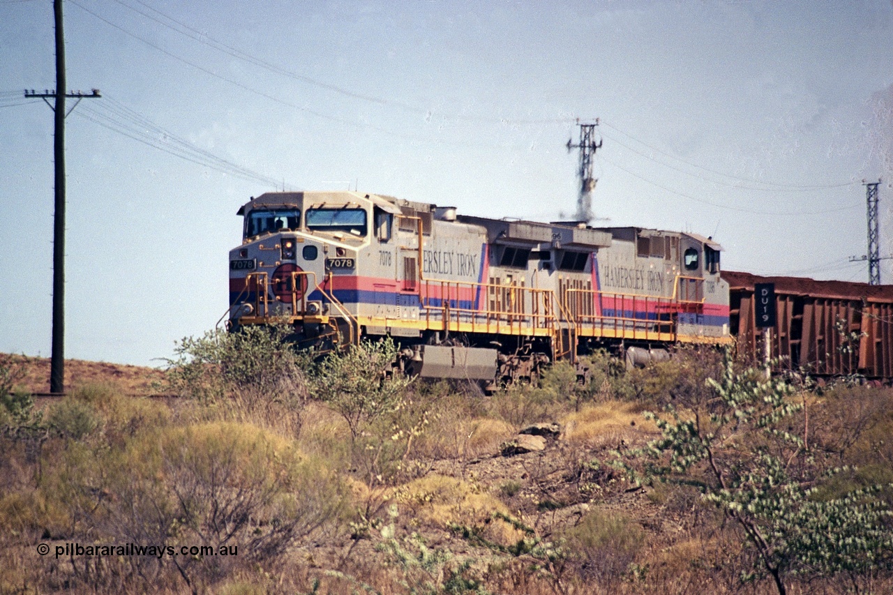 253-01
Dugite near the 64 km on the Dampier - Tom Price railway, a loaded Hamersley Iron train headed up by General Electric 9-44CW units 7078, from the original order, serial number 47757 and 7096, from the second order, serial number 52843 arrive taking the mainline to cross an empty which is in the passing track.
Keywords: 7078;GE;Dash-9-44CW;47757;