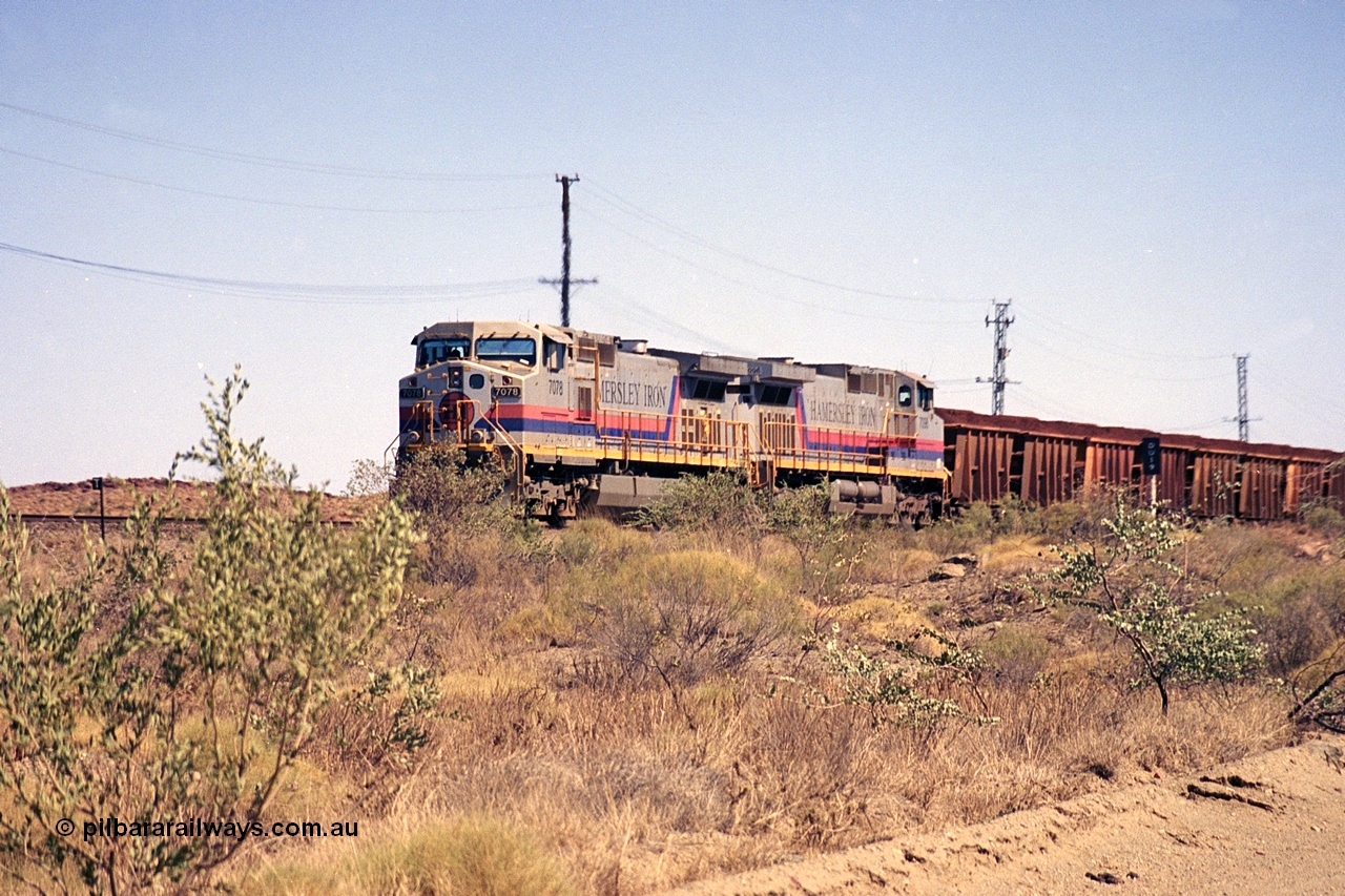 253-02
Dugite near the 64 km on the Dampier - Tom Price railway, a loaded Hamersley Iron train headed up by General Electric 9-44CW units 7078, from the original order, serial number 47757 and 7096, from the second order, serial number 52843 arrive taking the mainline to cross an empty which is in the passing track.
Keywords: 7078;GE;Dash-9-44CW;47757;
