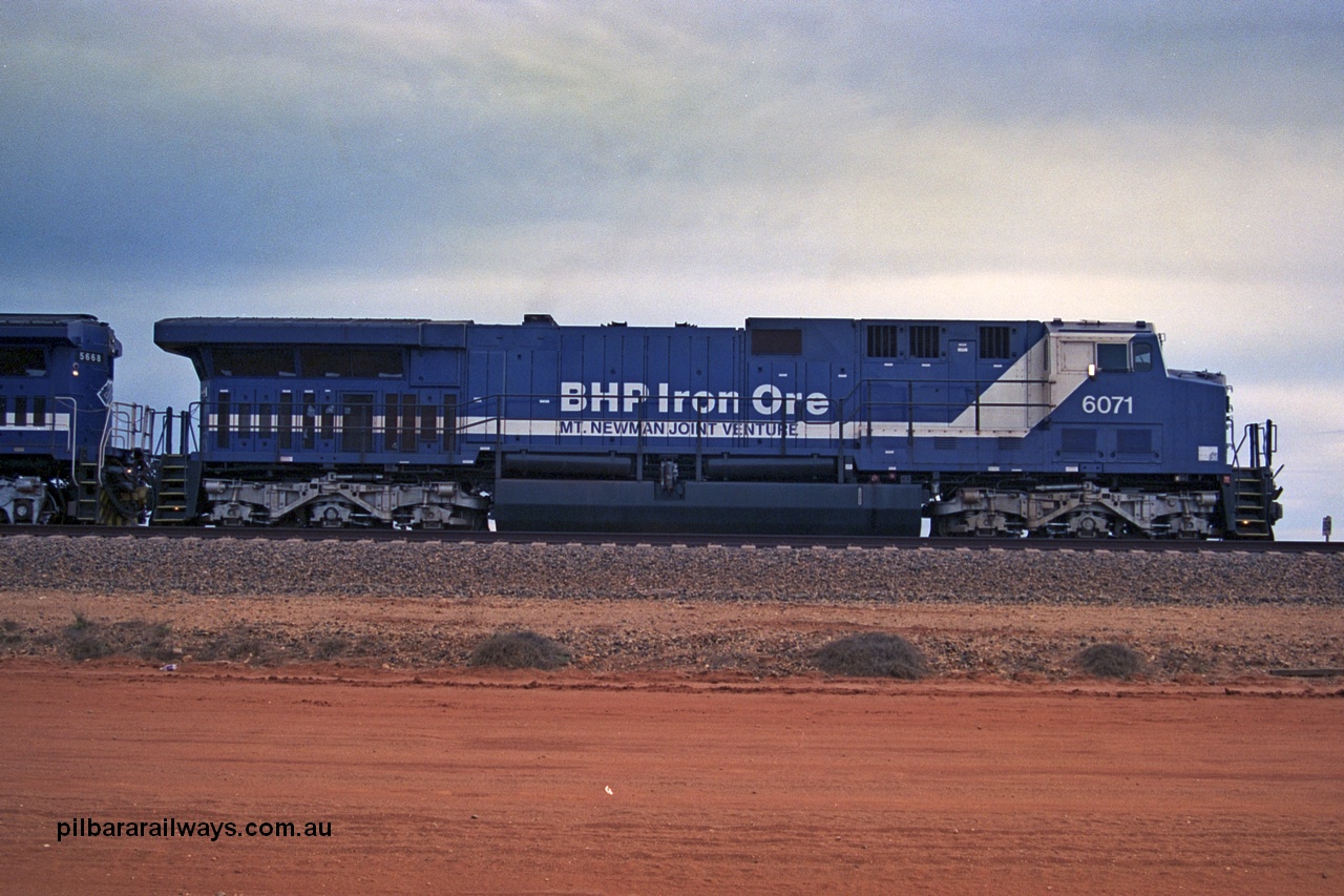 254-20
Bing Siding, an empty train awaits departure time behind 6071 an General Electric built AC6000 model with serial number 51063. The locomotive has not yet been named. Side view. September 2001.
Keywords: 6071;GE;AC6000;51063;