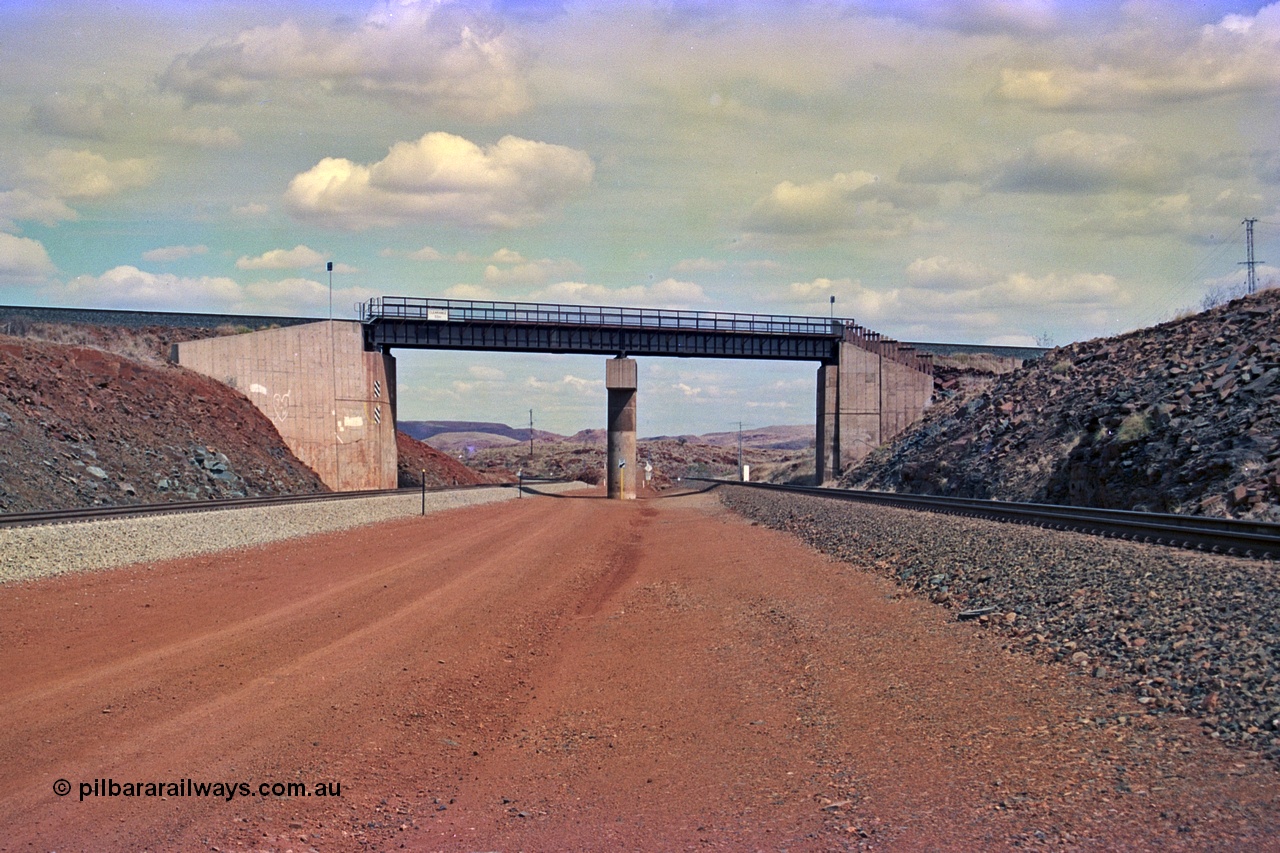 255-20
Western Creek, looking south alongside the Hamersley Iron Dampier to Tom Price line on the right with the new Robe River interconnecting line on the left as both lines pass under the Robe River Cape Lambert to Deepdale line bridge. Geodata [url=https://goo.gl/maps/ajP32PY1Zd11zPRx9]location here[/url]. May 2002.
