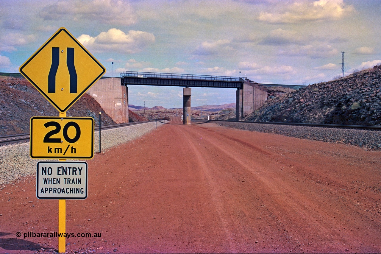 255-22
Western Creek, looking south alongside the Hamersley Iron Dampier to Tom Price line on the right with the new Robe River interconnecting line on the left as both lines pass under the Robe River Cape Lambert to Deepdale line bridge. Geodata [url=https://goo.gl/maps/ajP32PY1Zd11zPRx9]location here[/url]. May 2002.
