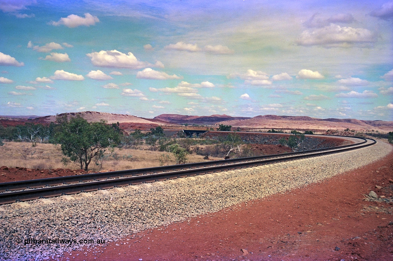 255-23
Western Creek, looking south alongside the Robe River interconnecting line with the Western Creek bridge, in the far background the pole line is the Hamersley Iron Dampier to Tom Price line. Geodata [url=https://goo.gl/maps/XKJRKgjAEhKLAzgu5]location here[/url]. May 2002.
