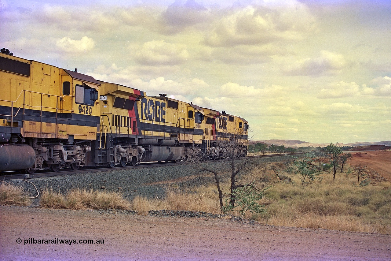 255-30
Western Creek at the 71 km on the Cape Lambert to Deepdale line an empty Robe River train powers upgrade behind the standard quad CM40-8M lash up led by Goninan CM40-8M unit 9425 and 9410 with serial number 2160-03 / 96-202. The Western Creek interconnecting line can be seen branching off to the right. Geodata [url=https://goo.gl/maps/fzacjsy5LHGwuSRg8]location here[/url]. May 2002.
Keywords: 9410;Goninan;GE;CM40-8M;2160-03/96-202;rebuild;Comeng-NSW;ALCo;M636;C-6096-5;