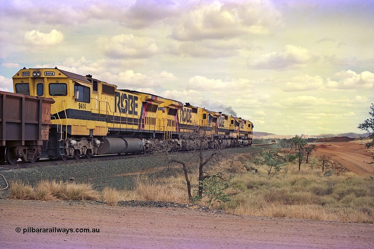 255-31
Western Creek at the 71 km on the Cape Lambert to Deepdale line an empty Robe River train powers upgrade behind the standard quad CM40-8M lash up led by Goninan CM40-8M unit 9425, 9410, 9420 and 9414 with serial number 8206-11 / 91-124. The Western Creek interconnecting line can be seen branching off to the right. Geodata [url=https://goo.gl/maps/fzacjsy5LHGwuSRg8]location here[/url]. May 2002.
Keywords: 9414;Goninan;GE;CM40-8M;8206-11/91-124;rebuild;AE-Goodwin;ALCo;M636;G6060-5;