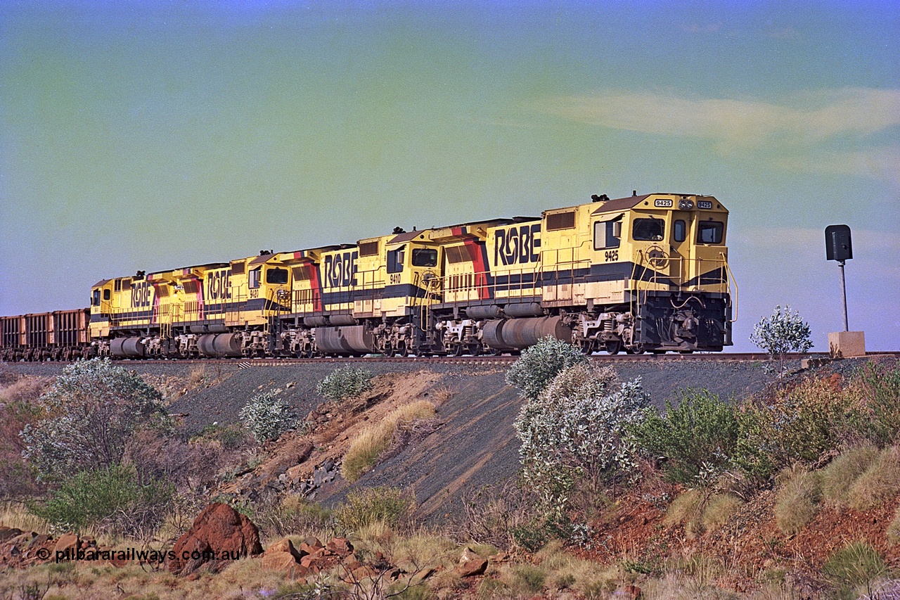256-01
Maitland Siding on the Cape Lambert to Deepdale railway has a late afternoon empty train with the quad CM40-8M working of 9425, 9410, 9420 and 9414 in the siding waiting for a cross with an opposing loaded train. At the time of this image Siding 3 or Murray Camp was unable to cross ore trains so Siding One - Harding or Siding Two - Maitland were used. May 2002.
Keywords: 9425;Goninan;GE;CM40-8M;6266-8/89-85;rebuild;AE-Goodwin;ALCo;M636;G-6041-4;