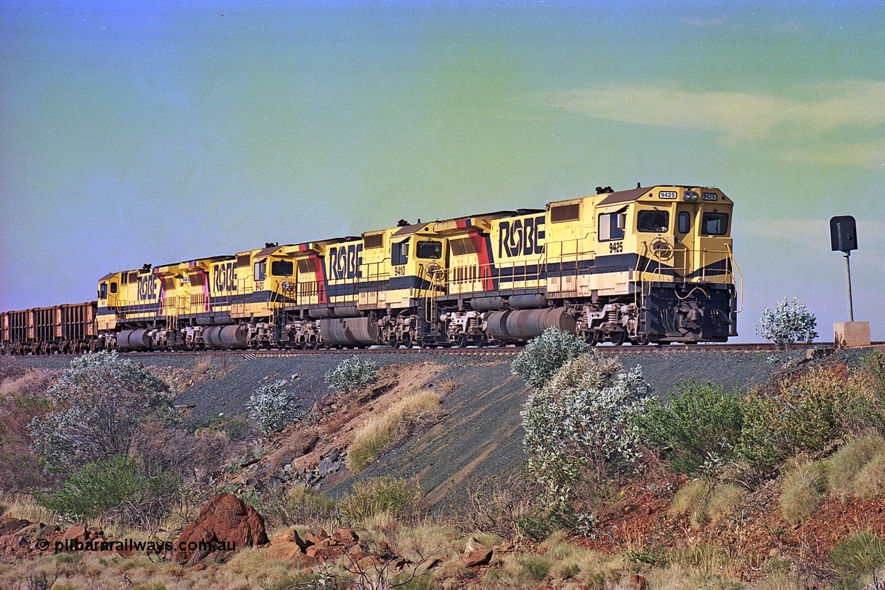 256-02
Maitland Siding on the Cape Lambert to Deepdale railway has a late afternoon empty train with the quad CM40-8M working of 9425, 9410, 9420 and 9414 in the siding waiting for a cross with an opposing loaded train. At the time of this image Siding 3 or Murray Camp was unable to cross ore trains so Siding One - Harding or Siding Two - Maitland were used. May 2002.
Keywords: 9425;Goninan;GE;CM40-8M;6266-8/89-85;rebuild;AE-Goodwin;ALCo;M636;G-6041-4;