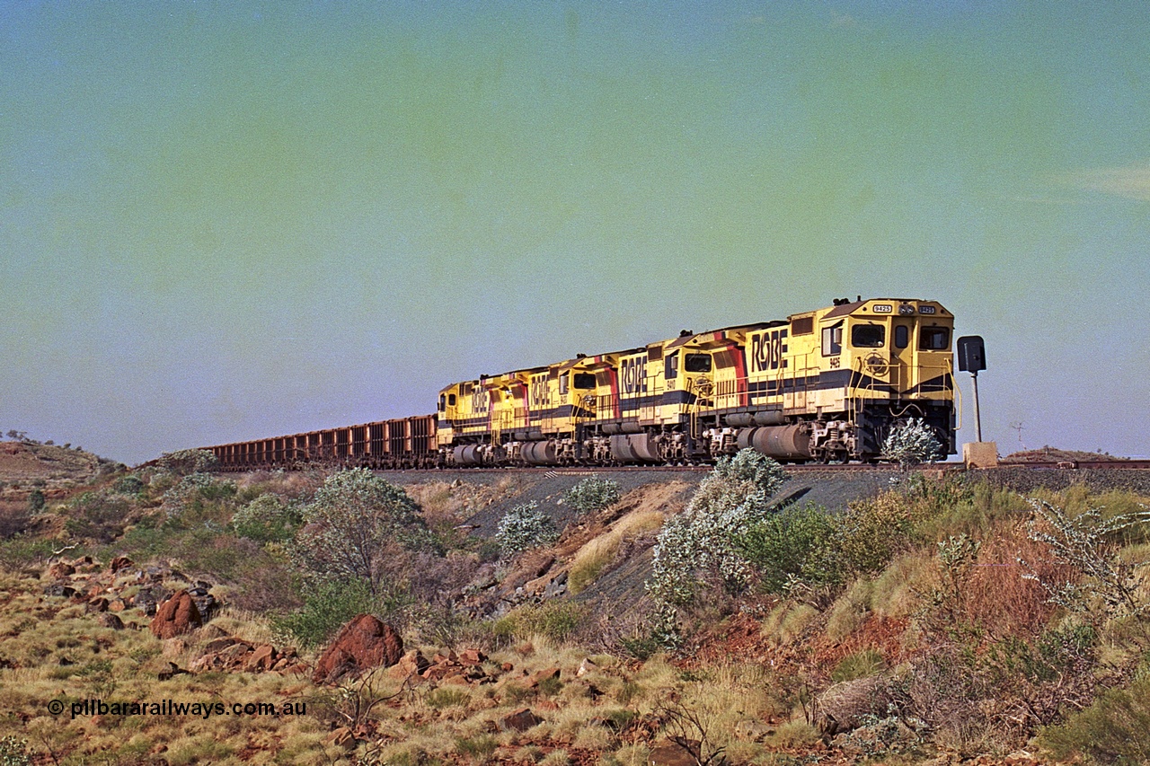 256-04
Maitland Siding on the Cape Lambert to Deepdale railway has a late afternoon empty train with the quad CM40-8M working of 9425, 9410, 9420 and 9414 in the siding waiting for a cross with an opposing loaded train. At the time of this image Siding 3 or Murray Camp was unable to cross ore trains so Siding One - Harding or Siding Two - Maitland were used. May 2002.
Keywords: 9425;Goninan;GE;CM40-8M;6266-8/89-85;rebuild;AE-Goodwin;ALCo;M636;G-6041-4;