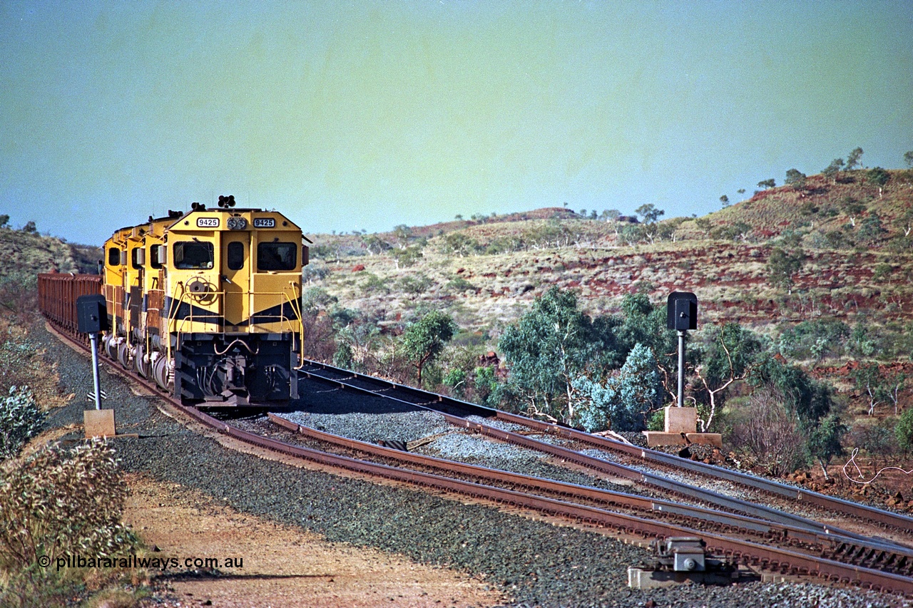 256-09
Maitland Siding on the Cape Lambert to Deepdale railway has a late afternoon empty train with the quad CM40-8M working of 9425, 9410, 9420 and 9414 in the siding waiting for a cross with an opposing loaded train. At the time of this image Siding 3 or Murray Camp was unable to cross ore trains so Siding One - Harding or Siding Two - Maitland were used. May 2002.
Keywords: 9425;Goninan;GE;CM40-8M;6266-8/89-85;rebuild;AE-Goodwin;ALCo;M636;G-6041-4;