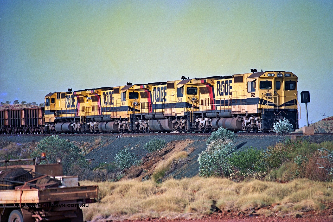 256-10
Maitland Siding on the Cape Lambert to Deepdale railway has a late afternoon empty train with the quad CM40-8M working of 9425, 9410, 9420 and 9414 in the siding waiting for a cross with an opposing loaded train. At the time of this image Siding 3 or Murray Camp was unable to cross ore trains so Siding One - Harding or Siding Two - Maitland were used. May 2002.
Keywords: 9425;Goninan;GE;CM40-8M;6266-8/89-85;rebuild;AE-Goodwin;ALCo;M636;G-6041-4;