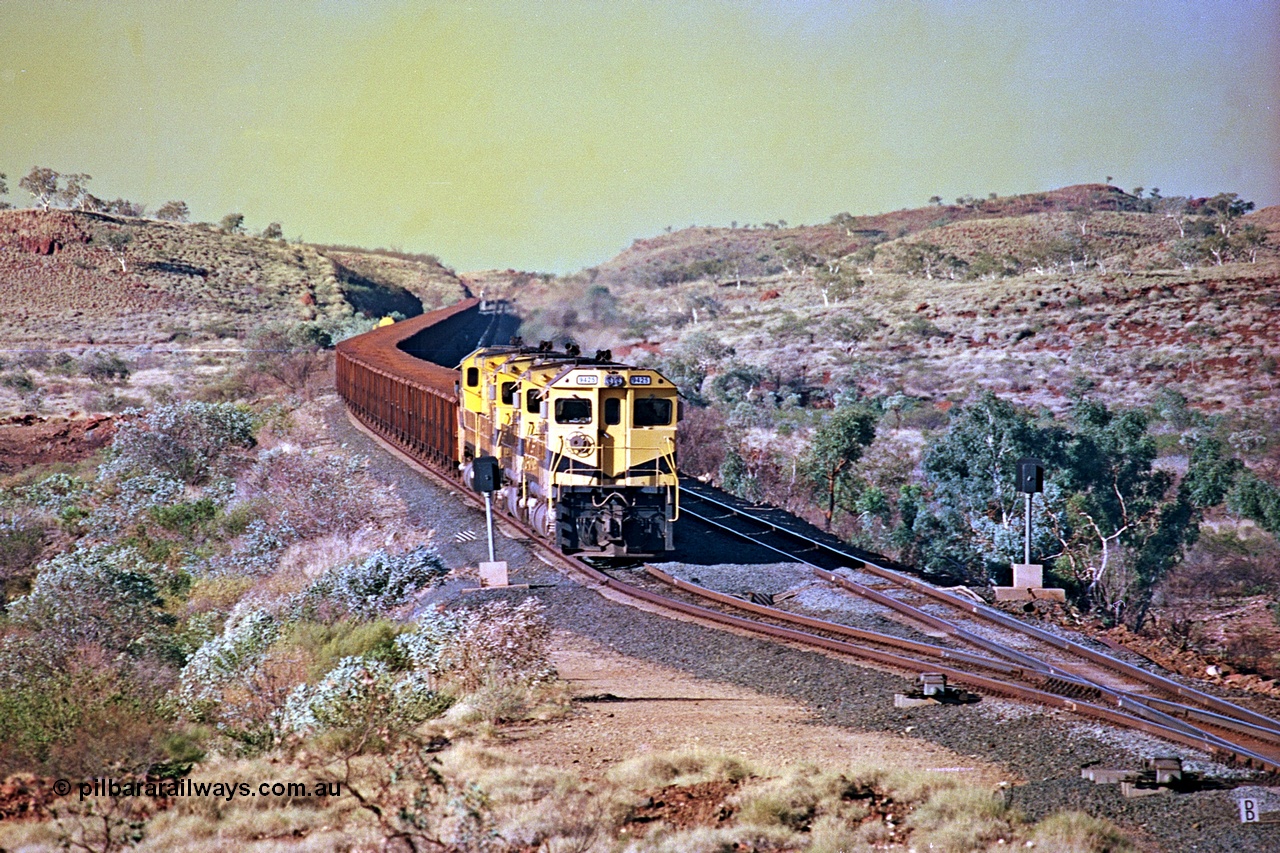 256-13
Maitland Siding on the Cape Lambert to Deepdale railway has a late afternoon empty train with the quad CM40-8M working of 9425, 9410, 9420 and 9414 in the siding waiting for a cross with an opposing loaded train. At the time of this image Siding 3 or Murray Camp was unable to cross ore trains so Siding One - Harding or Siding Two - Maitland were used. May 2002.
Keywords: 9425;Goninan;GE;CM40-8M;6266-8/89-85;rebuild;AE-Goodwin;ALCo;M636;G-6041-4;