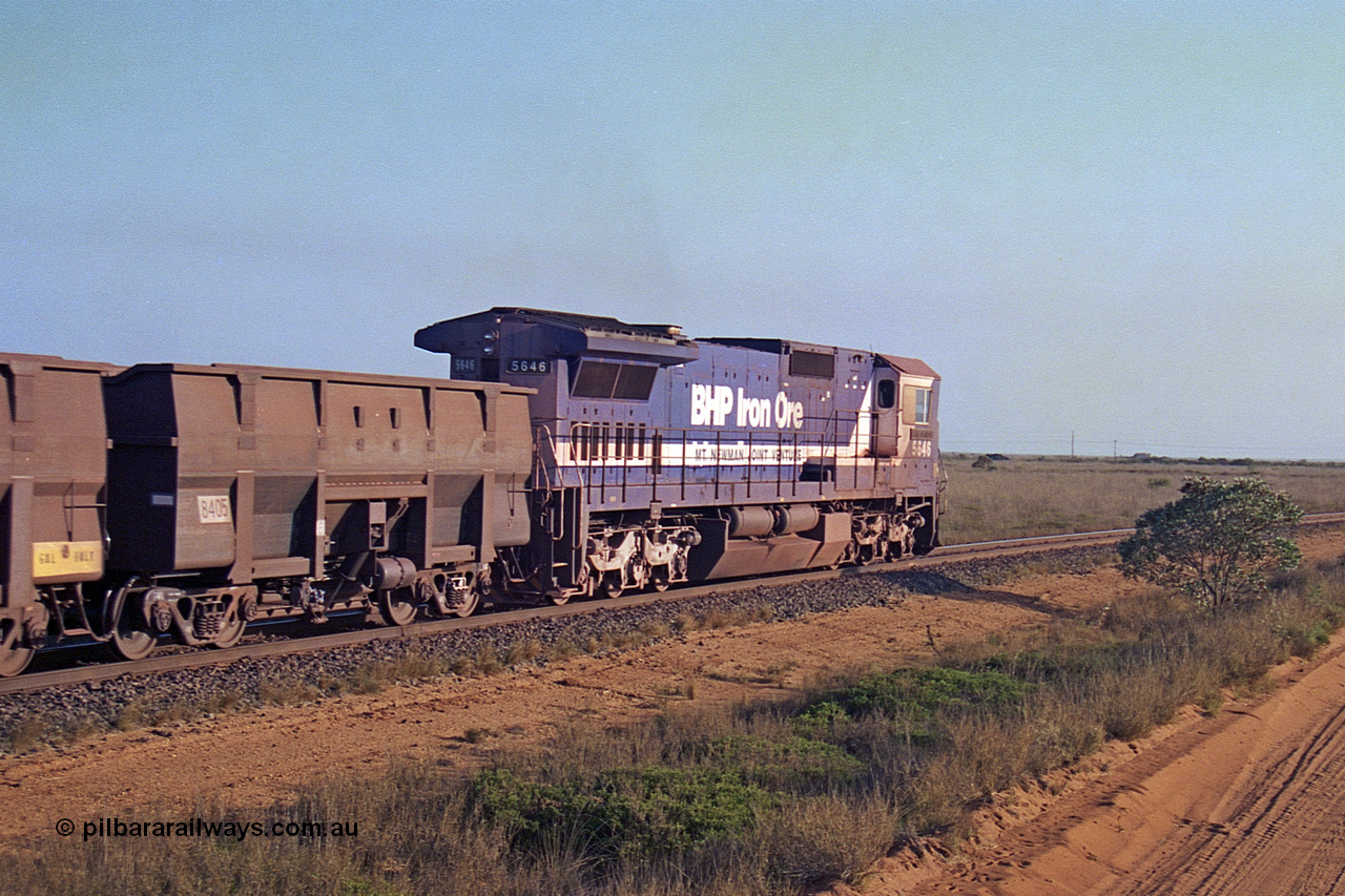 257-26
Goldsworthy Junction, an empty train runs between the junction and the Broome Rd crossing behind the standard single locomotive 5646 'White Springs', a Goninan 1992 built GE CM40-8 model with serial number 5244-11 / 92-135, one of a pair of new build locos financed by Goldsworthy. Late 2001.
Keywords: 5646;Goninan;GE;CM40-8;8244-11/92-135;