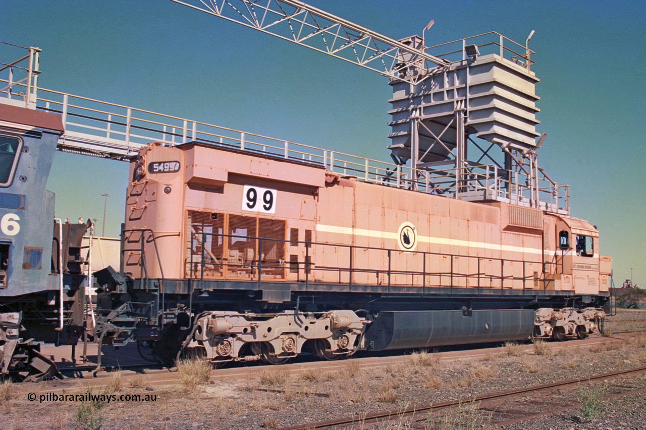 258-19
Nelson Point, old Loco Prep, Mt Newman Mining's last in-service ALCo M636 unit 5499 serial C6096-4 built by Comeng NSW sits awaiting partial dismantling before being sent by road to Rail Heritage WA's museum at Bassendean, Perth for preservation. May 2002.
Keywords: 5499;Comeng-NSW;MLW-ALCo;M636;C6096-4;