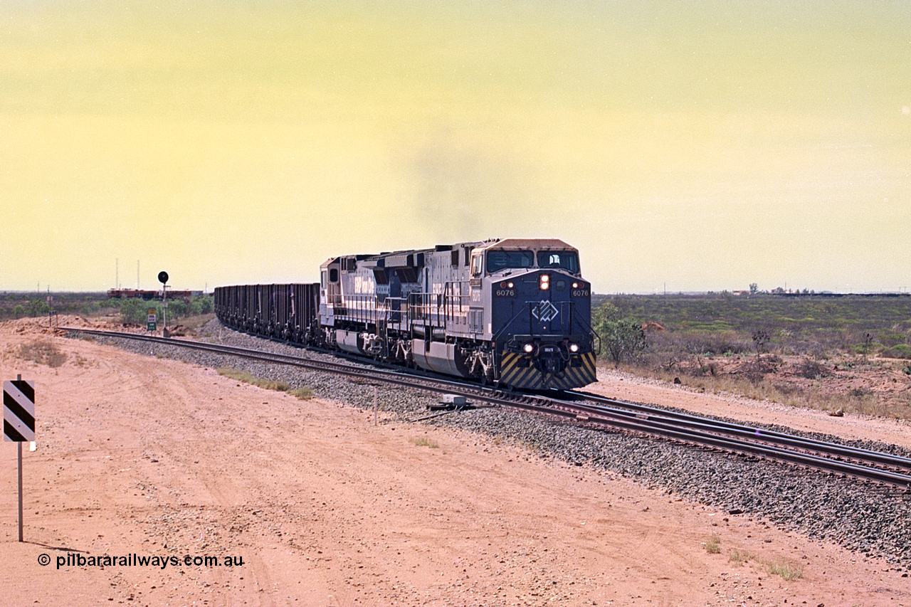 267-05
Goldsworthy Junction, BHP's 1230 empty departure behind General Electric AC6000 unit 6076 'Mt Goldsworthy' serial number 51068 leads CM40-8MEFI 5669 on the point with mid-train units CM40-8M units 5651 and 5645 104 waggons back with 104 waggons trailing. 1247 hrs 12th of April 2002.
Keywords: 6076;GE;AC6000;51068;