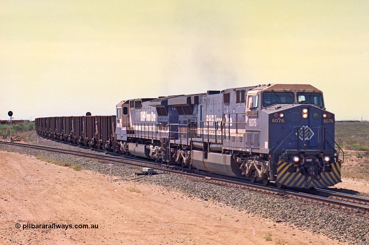 267-06
Goldsworthy Junction, BHP's 1230 empty departure behind General Electric AC6000 unit 6076 'Mt Goldsworthy' serial number 51068 leads CM40-8MEFI 5669 on the point with mid-train units CM40-8M units 5651 and 5645 104 waggons back with 104 waggons trailing. 1247 hrs 12th of April 2002.
Keywords: 6076;GE;AC6000;51068;