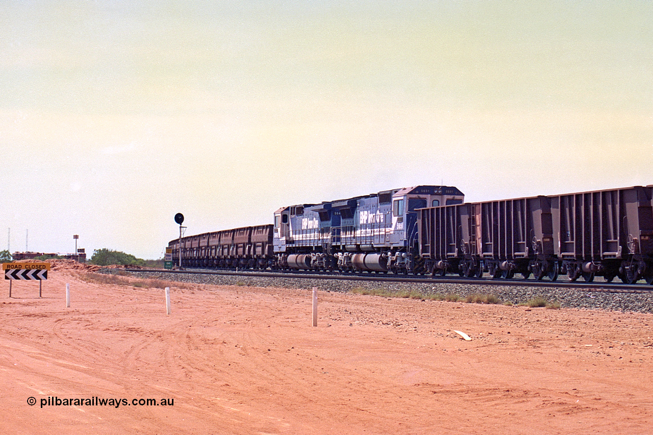 267-10
Goldsworthy Junction, BHP's 1230 empty departure mid-train units Goninan rebuild CM40-8M GE units 5651 'Tobata' serial number 8412-08 / 93-142 and 5645 'Sherlock' serial number 8281-11 / 92-134 104 waggons from the lead with 104 waggons trailing. The line curving away to the left is the Goldsworthy line to Boodarie and Finucane Island. 1247 hrs Friday 12th of April 2002.
Keywords: 5651;Goninan;GE;CM40-8M;8412-08/93-142;rebuild;AE-Goodwin;ALCo;M636C;5472;G6047-4;