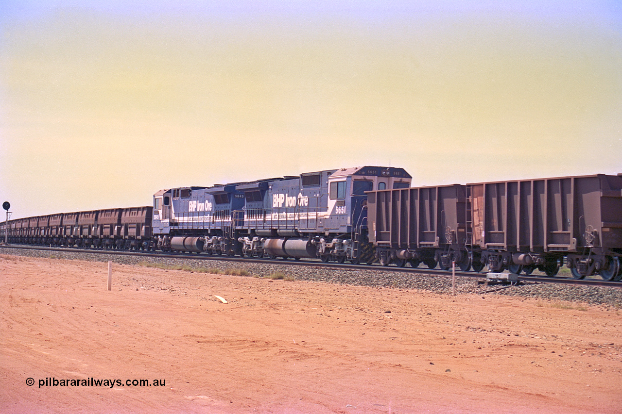 267-11
Goldsworthy Junction, BHP's 1230 empty departure mid-train units Goninan rebuild CM40-8M GE units 5651 'Tobata' serial number 8412-08 / 93-142 and 5645 'Sherlock' serial number 8281-11 / 92-134 104 waggons from the lead with 104 waggons trailing. The line curving away to the left is the Goldsworthy line to Boodarie and Finucane Island. 1247 hrs Friday 12th of April 2002.
Keywords: 5651;Goninan;GE;CM40-8M;8412-08/93-142;rebuild;AE-Goodwin;ALCo;M636C;5472;G6047-4;