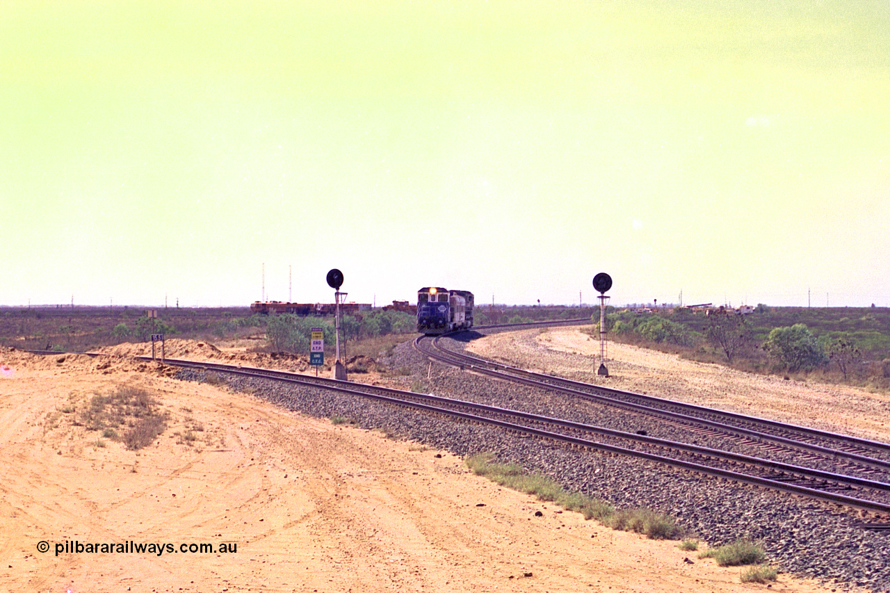 267-15
Goldsworthy Junction, the Sundowner Special is on the Newman mainline leg of the Goldsworthy Junction and triangle, with the Sundowner coach in between CM40-8M GE unit 5634 'Boodarie' serial number 8151-07 / 91-120 and sister CM40-8M 5653. This train, and the empty before it, were delayed due to a jamming switch for the transfer road where Tamper 2 and Ballast Regulator 31 can be seen holding track. The road curving around to the left is the Goldsworthy mainline to Boodarie and Finucane Island. Friday 12th of April 2002.
Keywords: 5634;Goninan;GE;CM40-8M;8151-07/91-120;rebuild;AE-Goodwin;ALCo;C636;5457;G6027-1;