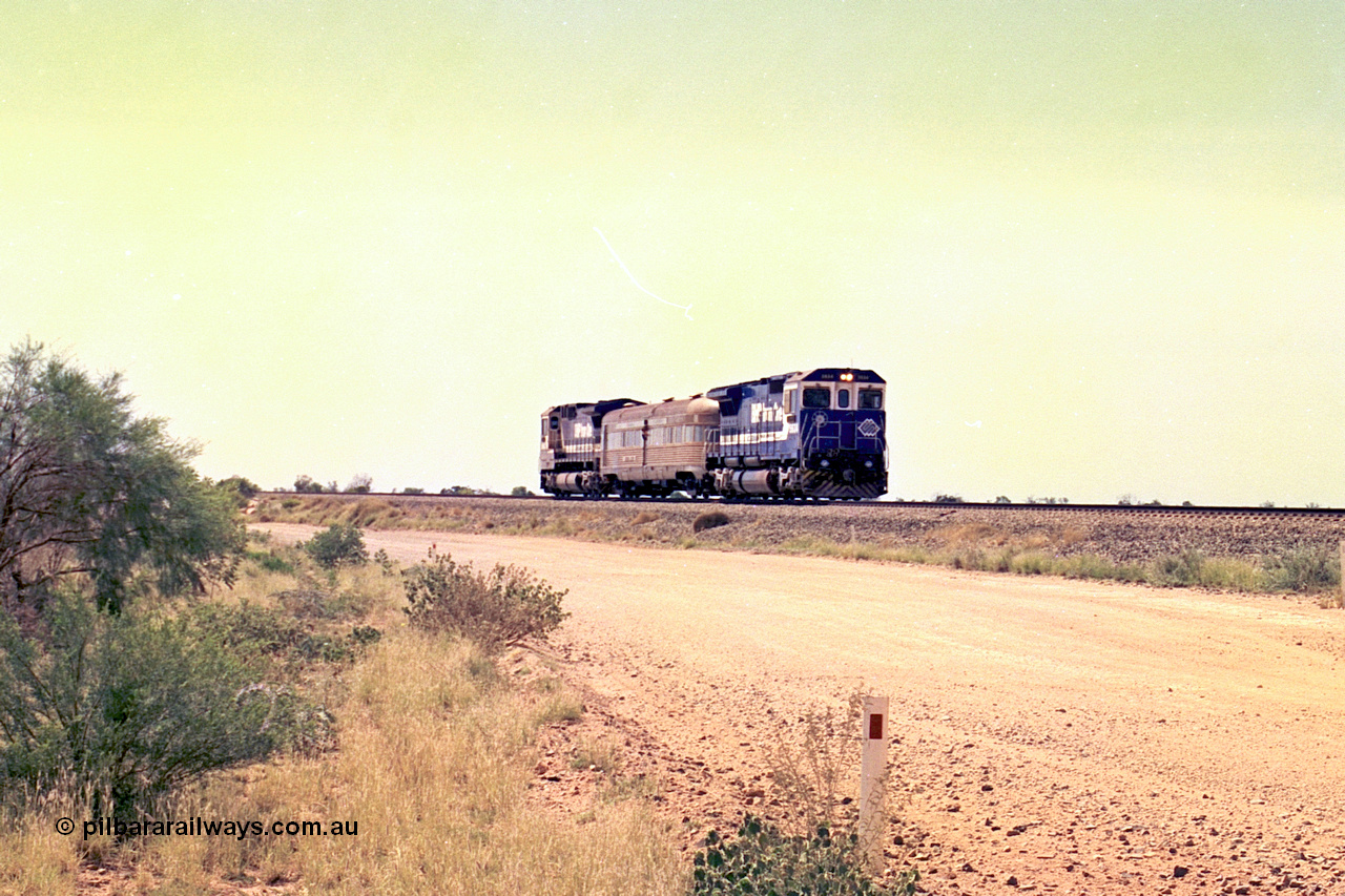 267-25
On approach to the 39 km Detector Site the Sundowner Special runs along the Newman Mainline behind BHP Iron Ore's Goninan rebuild CM40-8M unit 5634 'Boodarie' serial number 8151-07 / 91-120 with sister 5653 on the rear. Friday 12th of April 2002.
Keywords: 5634;Goninan;GE;CM40-8M;8151-07/91-120;rebuild;AE-Goodwin;ALCo;C636;5457;G6027-1;
