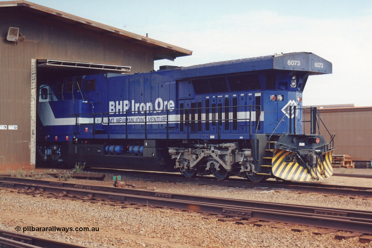 283-02
Nelson Point, BHP wheel lathe sees BHP's big GE AC6000 unit 6073 'Fortescue' serial number 51065 on shed having wheel attention to the leading bogie. May 2002.
Keywords: 6073;GE;AC6000;51065;