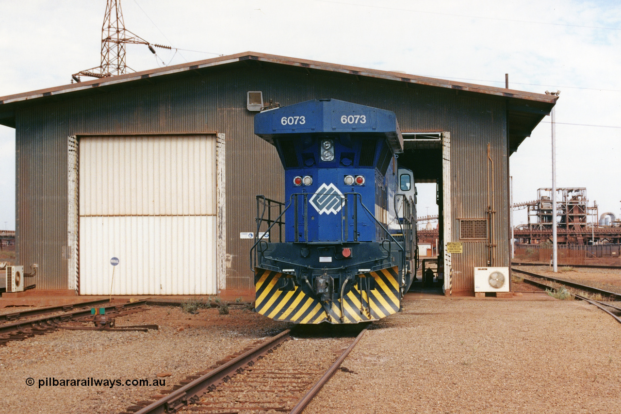 283-03
Nelson Point, BHP wheel lathe sees BHP's big GE AC6000 unit 6073 'Fortescue' serial number 51065 on shed having wheel attention to the leading bogie. May 2002.
Keywords: 6073;GE;AC6000;51065;
