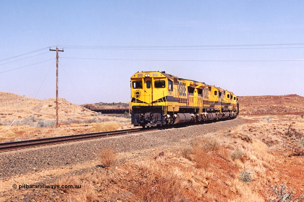 283-15
At the 45.4 km grade crossing on the Robe River line, loaded train easers around the curve behind the standard quad Goninan CM40-8M units led by 9414 serial number 8206-11 / 91-124 and rebuilt from the final of the original five ALCo units ordered from construction. 22nd of May 2002.
Keywords: 9414;Goninan;GE;CM40-8M;8206-11/91-124;rebuild;AE-Goodwin;ALCo;M636;G6060-5;