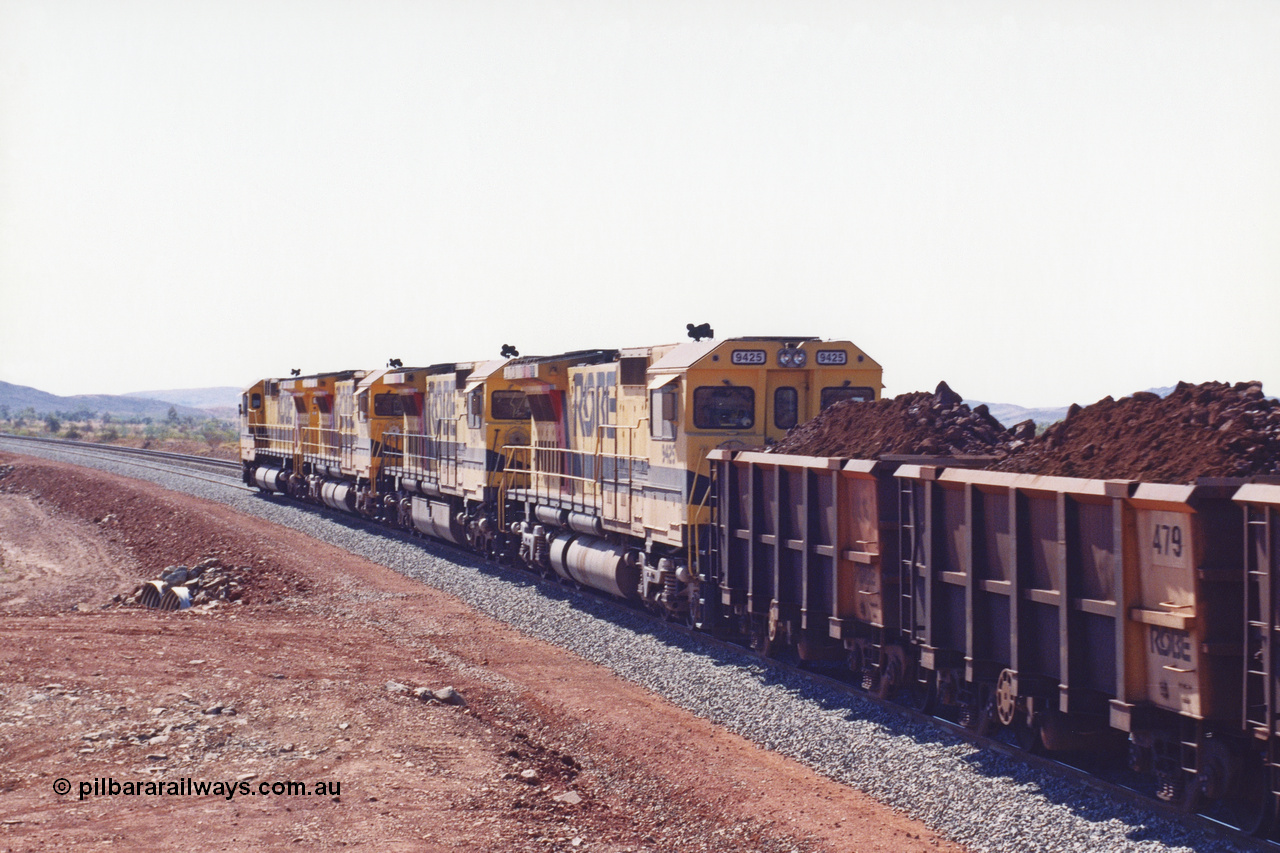 283-28
Harding Siding, quad Robe River CM40-8M units 9414, 9420, 9410 and 9425 lead their 202 loaded ore waggons through the passing track at Siding 1 (Harding) following recent extension of the loop and renaming to Harding. The extension is at the north end to accommodate the new West Angelas trains of up to 240 waggons. Wednesday 22nd May 2002.
Keywords: 9425;Goninan;GE;CM40-8M;6266-8/89-85;rebuild;AE-Goodwin;ALCo;M636;G-6041-4;