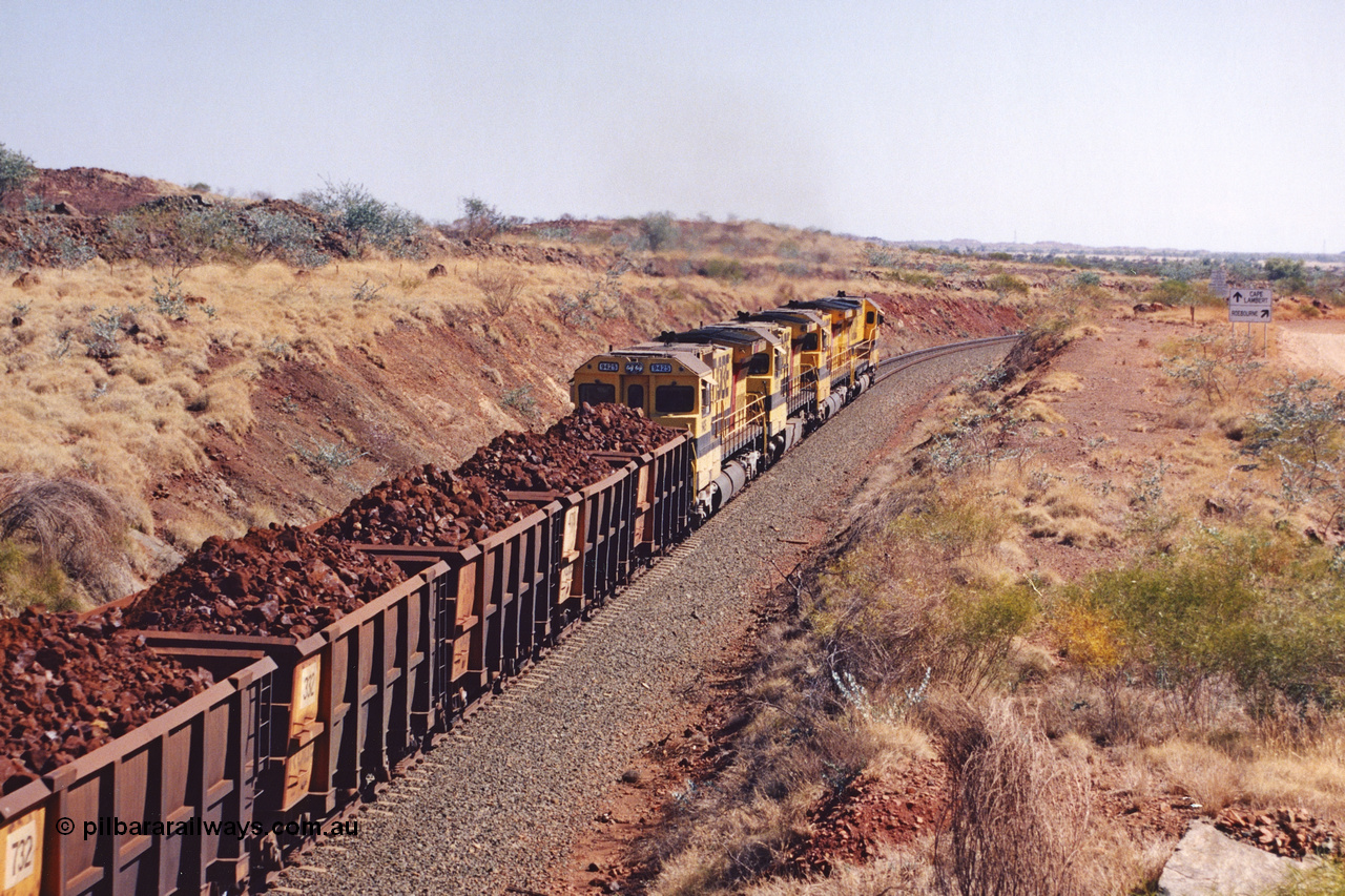 283-37
Near Woodbrook, quad Robe River CM40-8M units 9414, 9420, 9410 and 9425 lead their 202 loaded ore waggons around the curve away from the 37.5 km pipe bridge and are now Cape Lambert bound. Wednesday 22nd May 2002.
