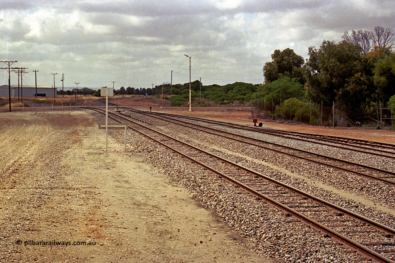 284-13
Narngulu yard looking south east across the grade crossing for Rudds Gully Road with the line to Mullewa curving away to the left and the line to Dongara curving away to the right. November 9, 2004.
