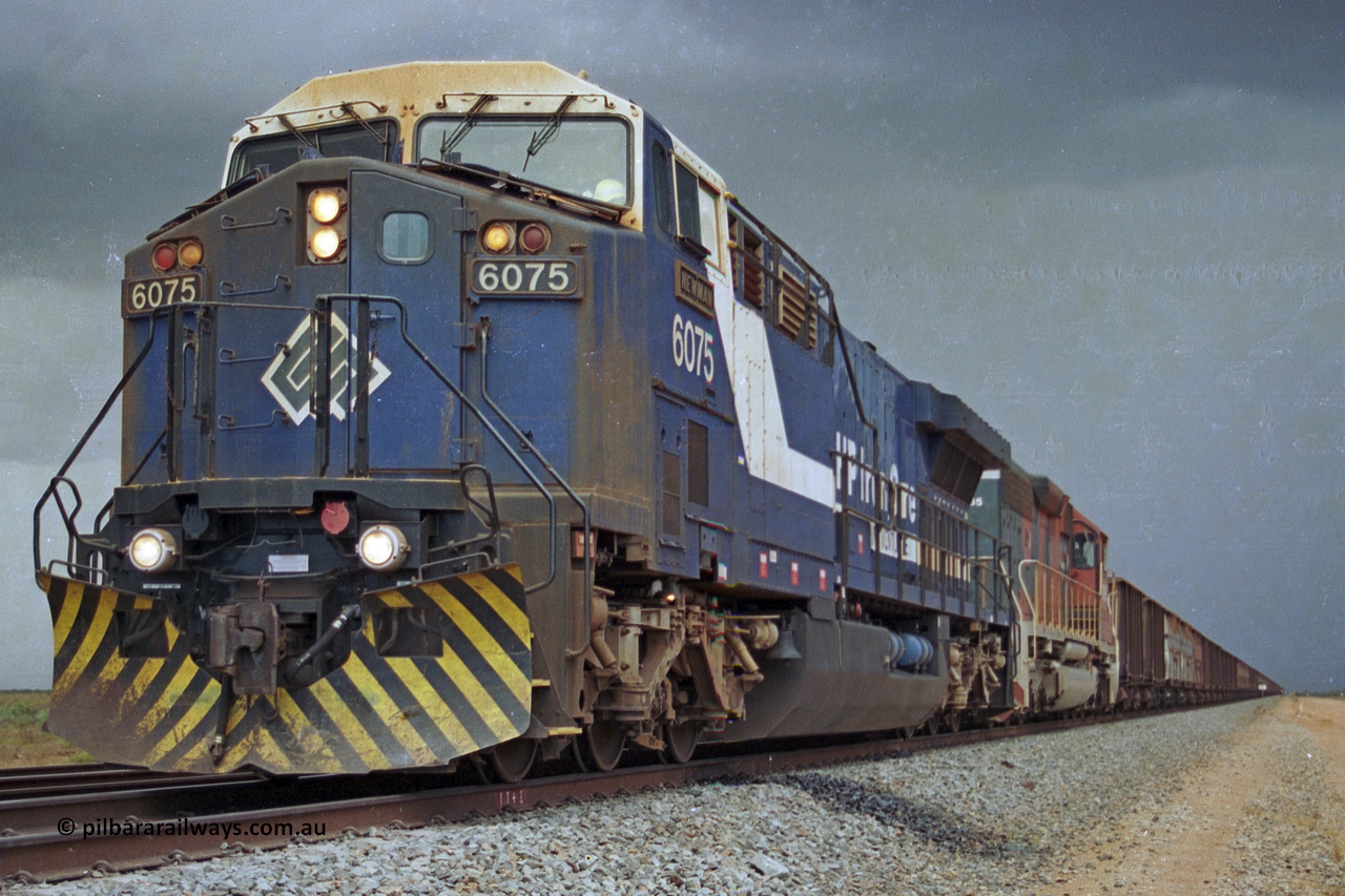 284-33
Bing Siding, 18 km south of Nelson Point and BHP's GE built AC6000 unit 6075 'Newman', serial number 51097, holds the mainline with a loaded train and EMD SD40R unit 3095 as second unit. Late 2004.
Keywords: 6075;GE;AC6000;51067;