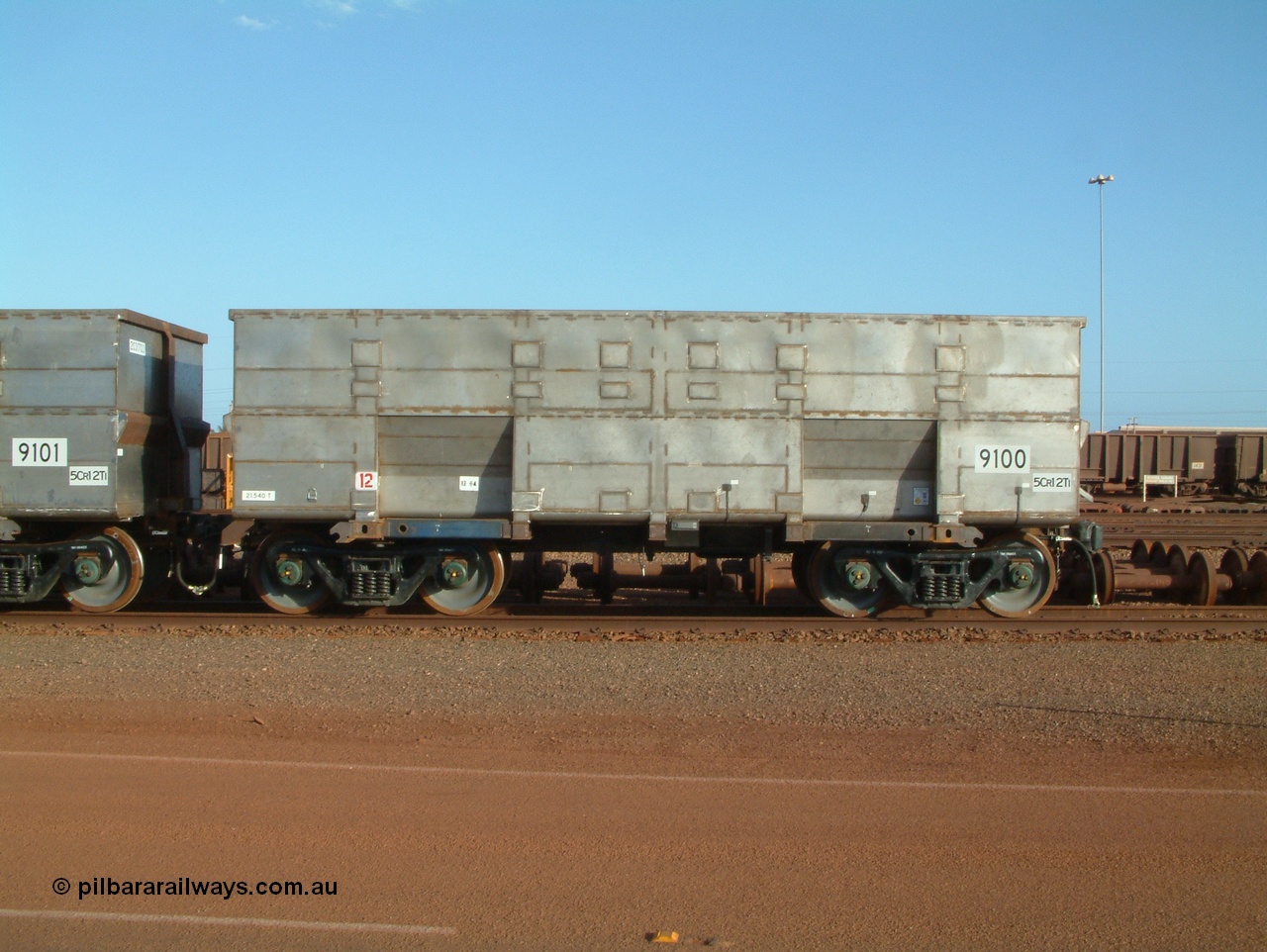041225 064625
Nelson Point Ore Car Repair Shops, brand new Bradken NSW built ore waggon and type leader 9100 asset number 2031702. These waggons are the latest additions to the fleet with 20 on order in total. They are made from the same 5Cr12Ti steel that the Goninan Golynx waggons are made. 9100 has been set up for use as a 'test' waggon with load sensors located all over it. 25th December 2004.
Keywords: 9100;Bradken-NSW;BHP-ore-waggon;