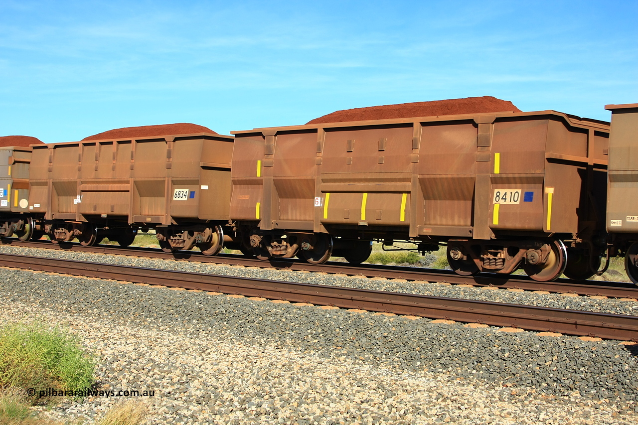 110620 1965r
Walla Siding, comparison between two BHP ore waggons loaded with Yandi fines of the Golynx design type, 8410 was built in November 2001 for bottom discharge on the Goldsworthy system with serial number 950088-340, while 6834 was built in 2008. The burn or weld marks are still visible on 8410 from when it was in GML service, now converted for rotary service, noticed the filled in end and the angle section along the top edge for support. 20th of June 2011.
Keywords: 8410;6834;Goninan-WA;Golynx;950088-340;GML-waggon;BHP-ore-waggon;