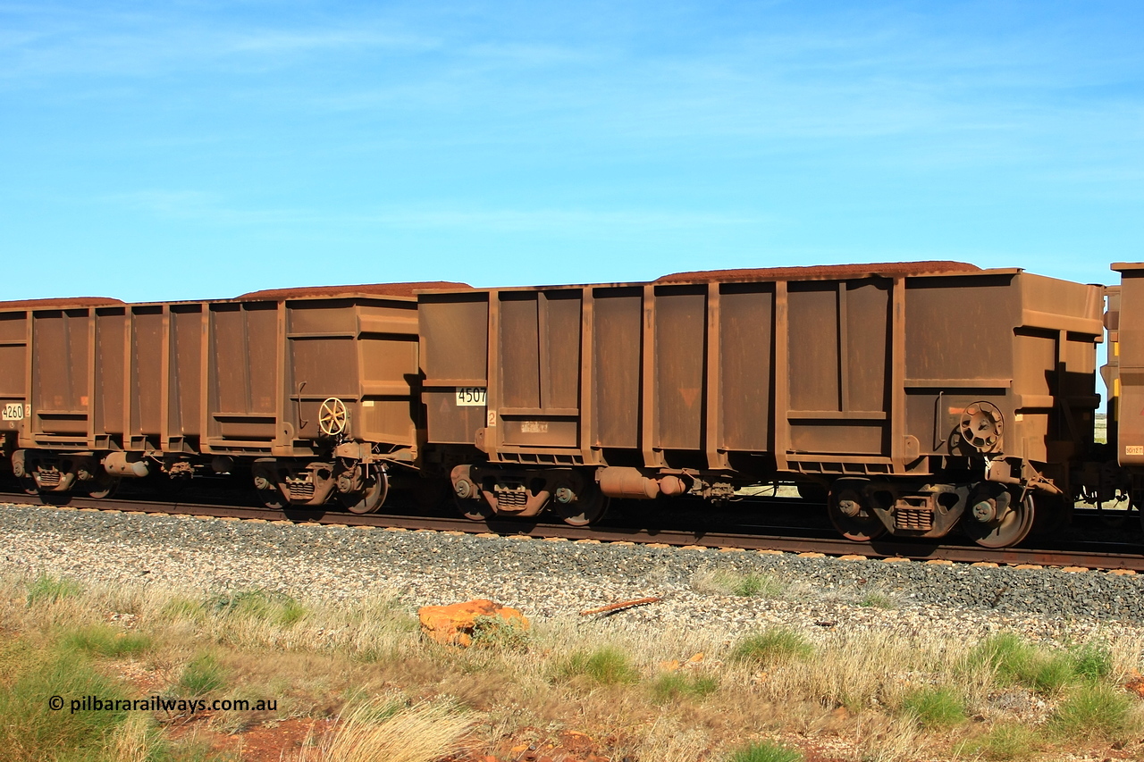 110620 2014r
Walla Siding, comparison between two empty BHP ore waggons with the tapered floor design. 4507 was built by Transfield WA in in 1976 in an order for eighteen waggons, while 4260 is a Goninan WA build from an order of one hundred and twenty-six waggons using 3CR12 stainless steel in an effort to eliminate internal painting and reducing wear on the waggon body, these were designated HC7081. 20th of June 2011.
Keywords: 4507;Transfield-WA;4260;Goninan-WA;HC7081;BHP-ore-waggon;
