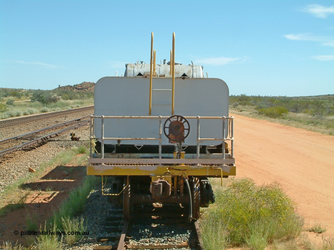 040419 102104
Abydos back track, riveted flat waggon 202 with three water tanks fitted, view of handbrake end, originally part of the 'camp train', modified by Mt Newman Mining railway workshops.
Keywords: BHP-flat-waggon;