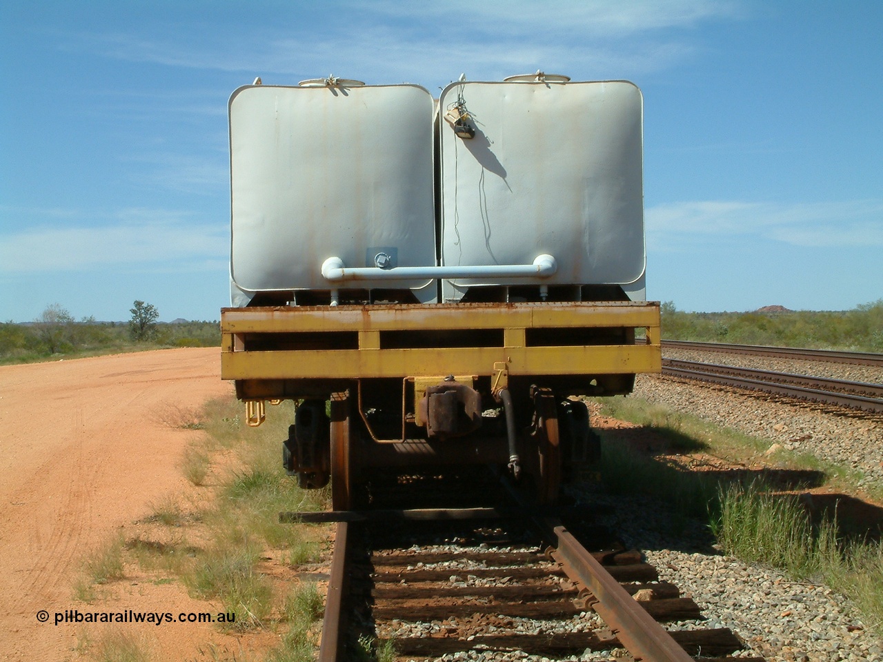 040419 102145
Abydos back track, riveted flat waggon 202 with three water tanks fitted, view of non-handbrake end, originally part of the 'camp train', modified by Mt Newman Mining railway workshops.
Keywords: BHP-flat-waggon;