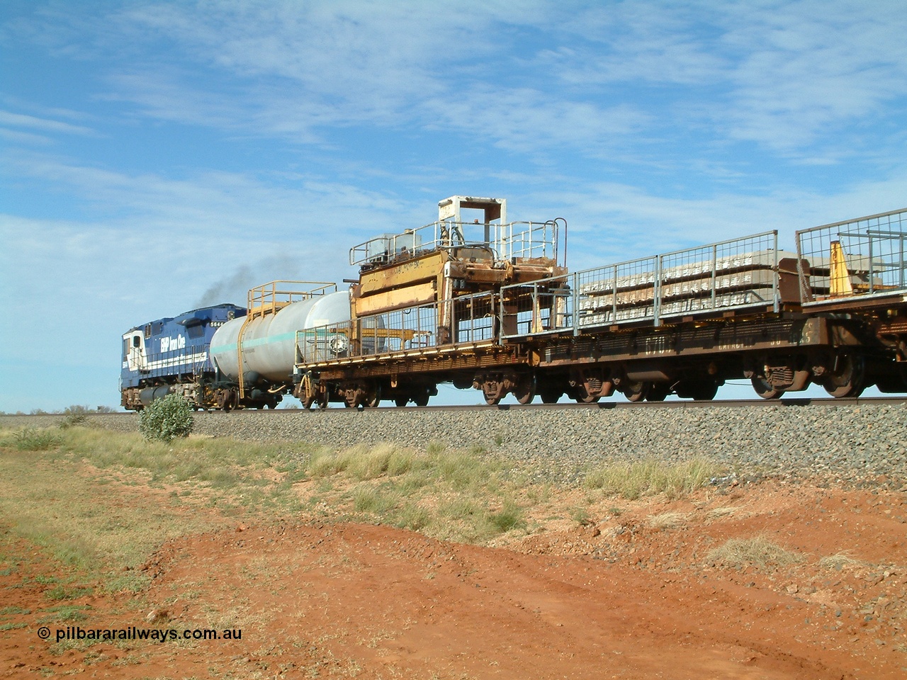 040502 085548
Mooka Siding, trailing view of the 'Pony' heading south, 50 ton waggon 6703, one of three 'special' waggons converted from Magor USA built ore waggons, loaded with concrete sleepers is closet to camera. 
Keywords: Magor-USA;BHP-pony-waggon;