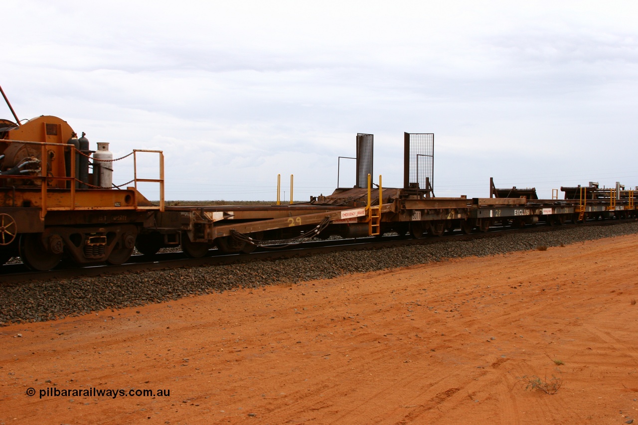 050522 2739
Goldsworthy Junction, rail recovery and transport train, 1st lead off waggon 6011, built by Scotts of Ipswich Qld in September 1970, the mesh guarding is for the winch cable. The chute arrangement for the discharging and recovery of rail is visible.
Keywords: Scotts-Qld;BHP-rail-train;