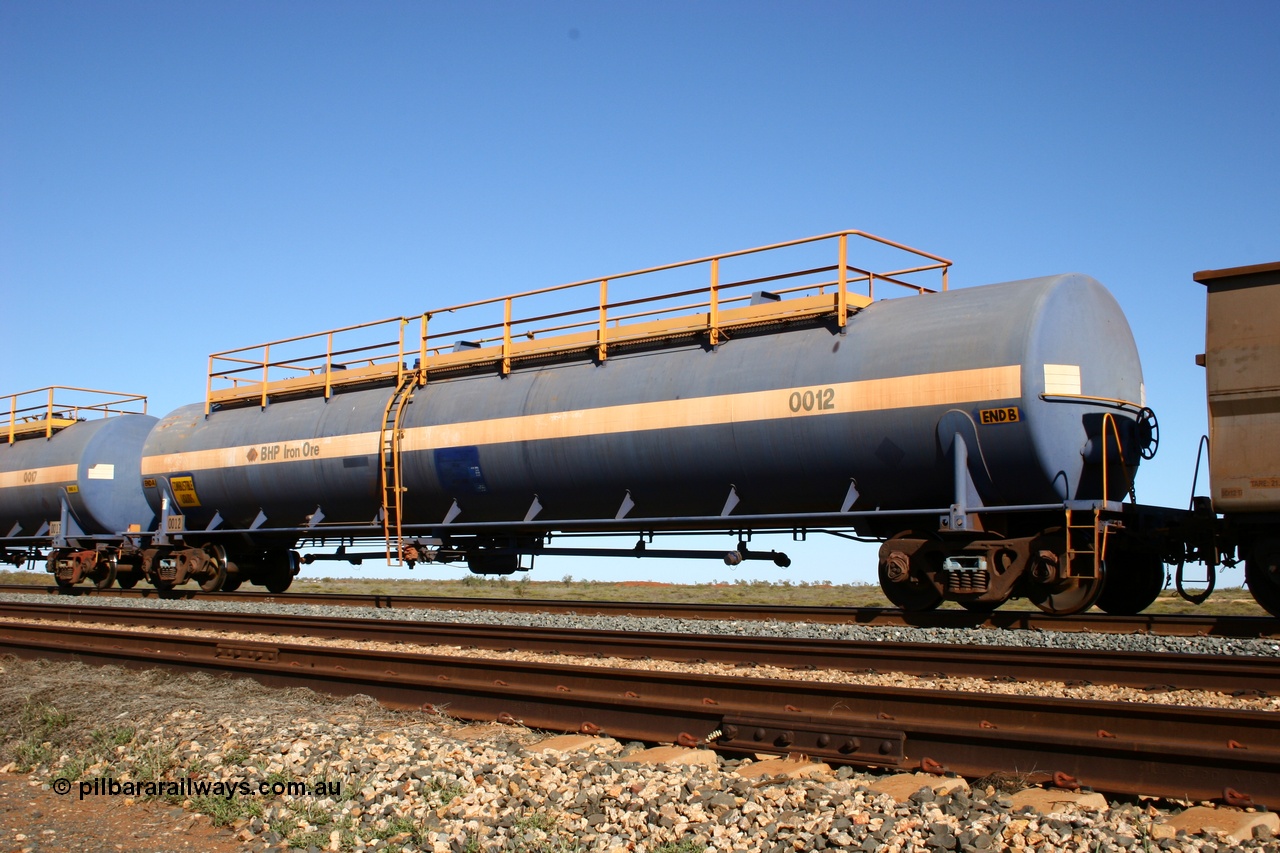 050704 3970
Bing Siding, empty 116 kL Comeng NSW built tank waggon 0012 from 1972, one of three such tank waggons, on the rear of a loaded ore train.
Keywords: Comeng-NSW;BHP-tank-waggon;
