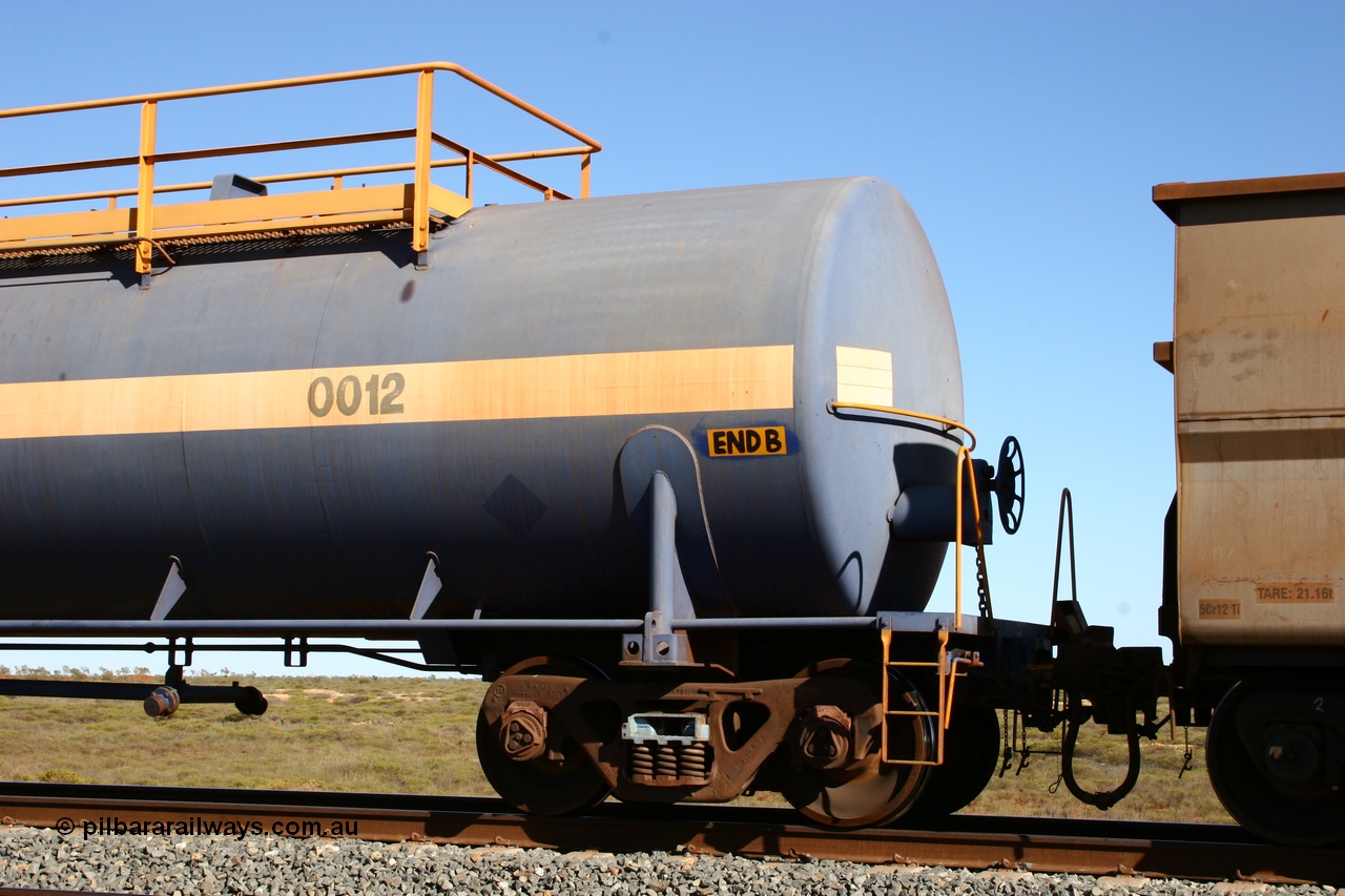 050704 3971
Bing Siding, empty 116 kL Comeng NSW built tank waggon 0012 from 1972, one of three such tank waggons, view of handbrake detail, on the rear of a loaded ore train.
Keywords: Comeng-NSW;BHP-tank-waggon;
