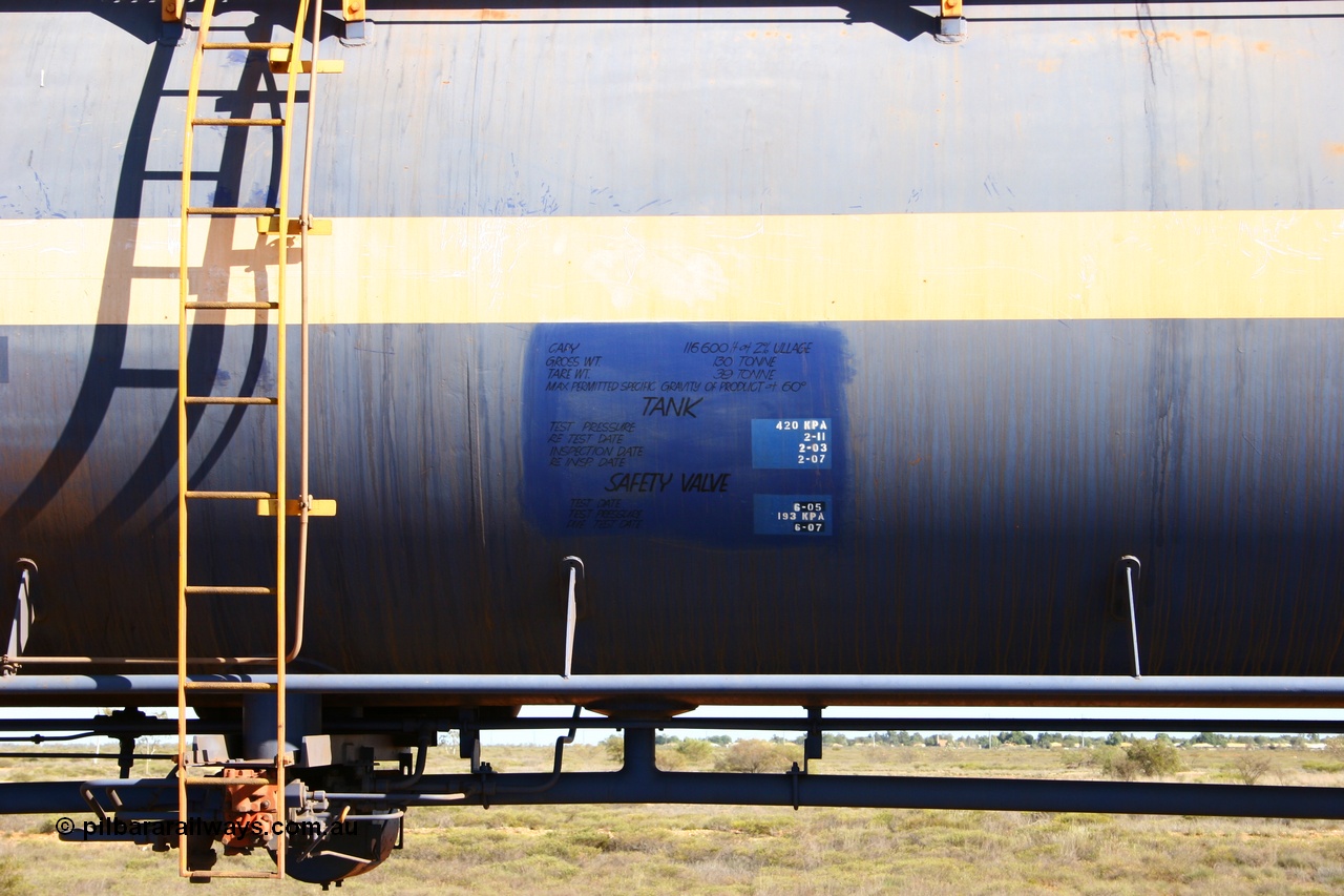 050704 3972
Bing Siding, empty 116 kL Comeng NSW built tank waggon 0012 from 1972, one of three such tank waggons, view of data placard, ladder and valving, on the rear of a loaded ore train.
Keywords: Comeng-NSW;BHP-tank-waggon;