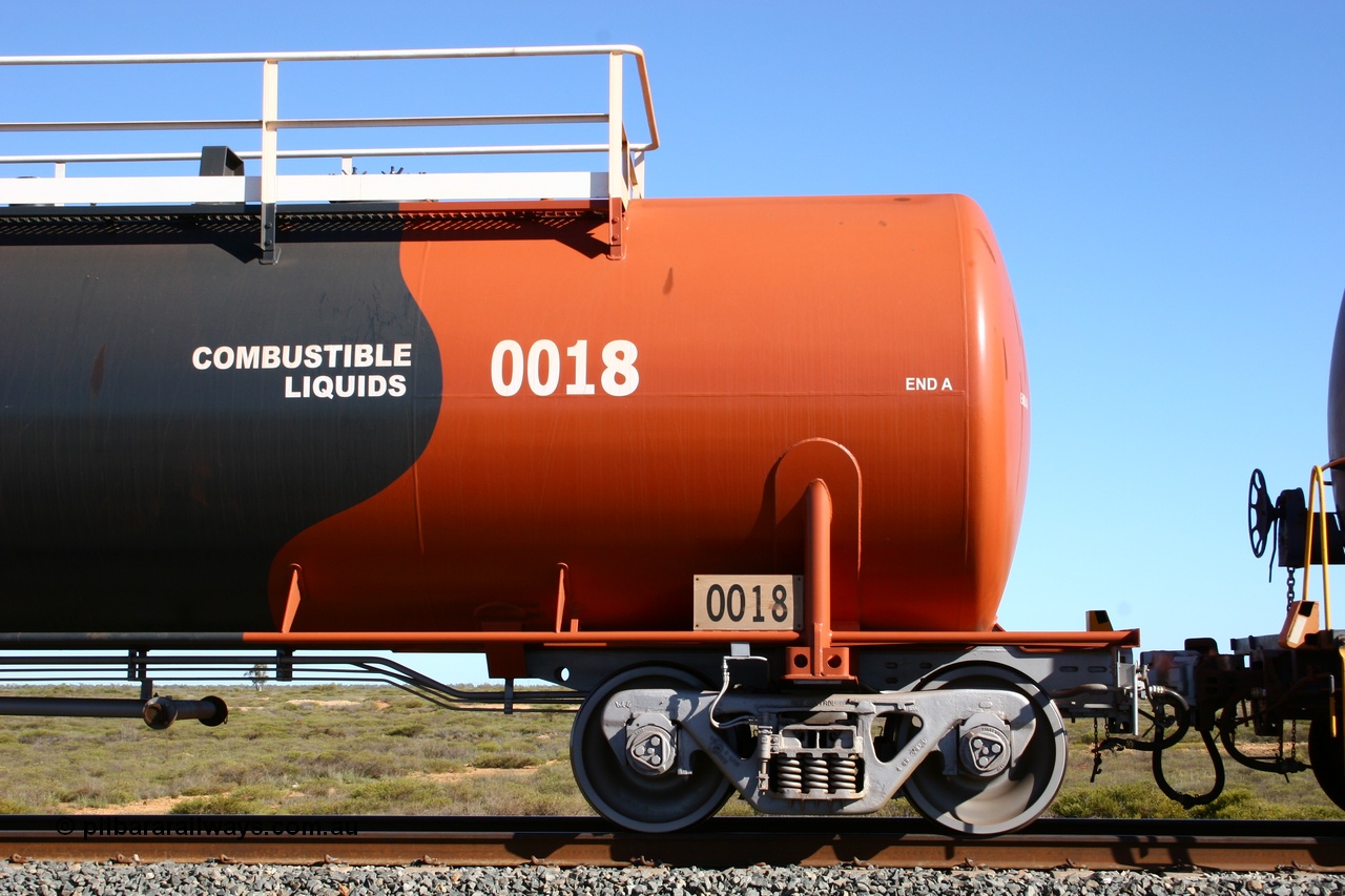 050704 3978
Bing Siding, empty 116 kL Comeng WA built tank waggon 0018 from 1974-5, one of six such tank waggons, detail of the A end and bogie, wearing the BHP Billiton Earth livery.
Keywords: Comeng-WA;BHP-tank-waggon;
