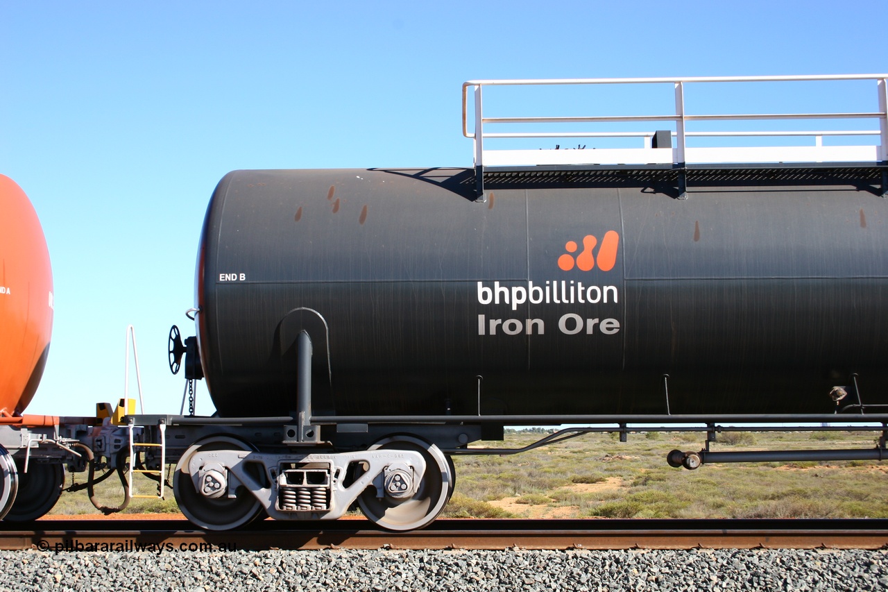050704 3980
Bing Siding, empty 116 kL Comeng WA built tank waggon 0018 from 1974-5, one of six such tank waggons, detail of the B end and bogie, wearing the BHP Billiton Earth livery.
Keywords: Comeng-WA;BHP-tank-waggon;