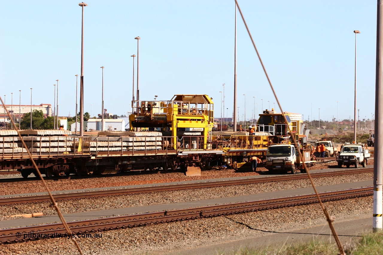 050724 4237
Nelson Point yard, flat waggons in service on the Pony re-laying train as transport waggons for sleepers, with a gantry car delivering concrete sleepers to replace the removed steel sleepers. The left waggon is an ex Goldsworthy Mining flat waggon with a Scotts of Ipswich built flat waggon with the gantry car on it, built in 1970 for then Mt Newman Mining Company.
Keywords: Scotts-Qld;BHP-pony-waggon;