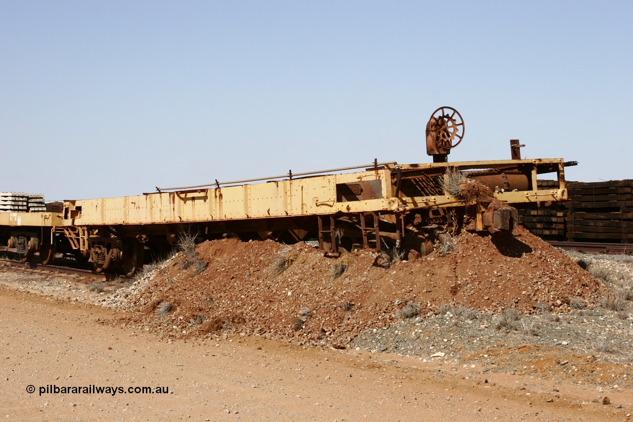 051001 5626
Flash Butt yard, heavily stripped down riveted waggon 206, possible original ballast waggon, number 206 was originally a waggon in the 'Camp Train' and appears to have USA origin, view of handbrake end, pushed into earth bund.
Keywords: BHP-flat-waggon;